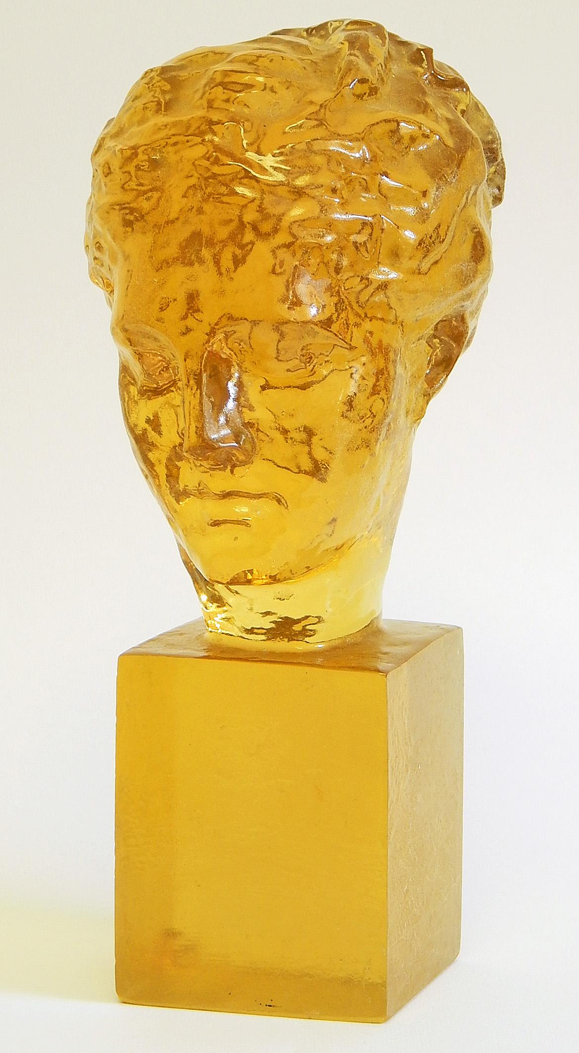 Translucent and glowing in a lovey shade of golden amber, this sculpture of an elegant woman's head was made by Dorothy Thorpe, one of the most prolific and important women designers in midcentury America. Based in Los Angeles, Thorpe designed sets