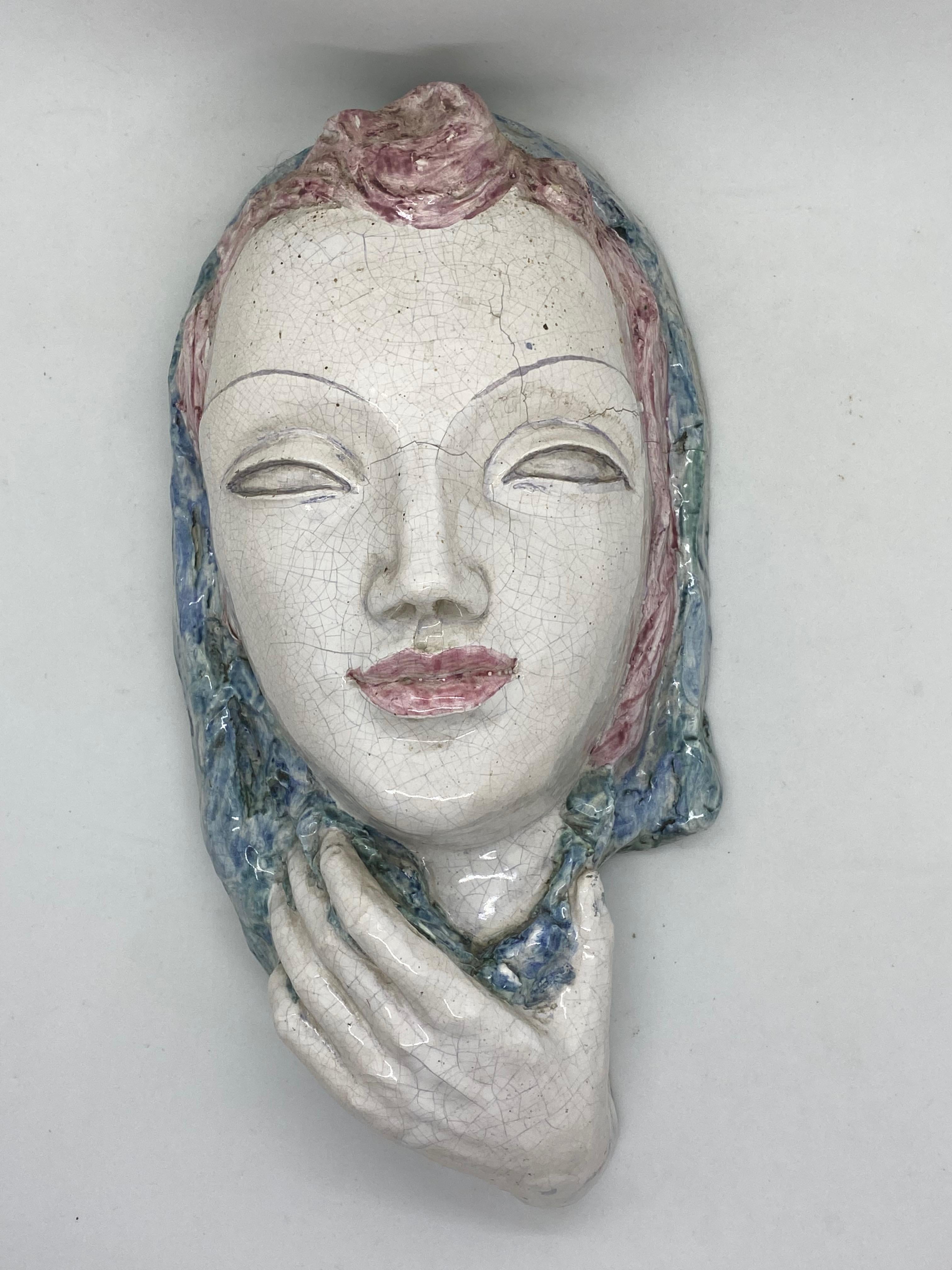 A beautiful vintage ceramic glazed wall mask of a female. It’s in the style of Vally Wieselthier. It would make a beautiful decoration on each wall. Made in the 1920s it displays the joy of that great era with a bold, yet classy statement.