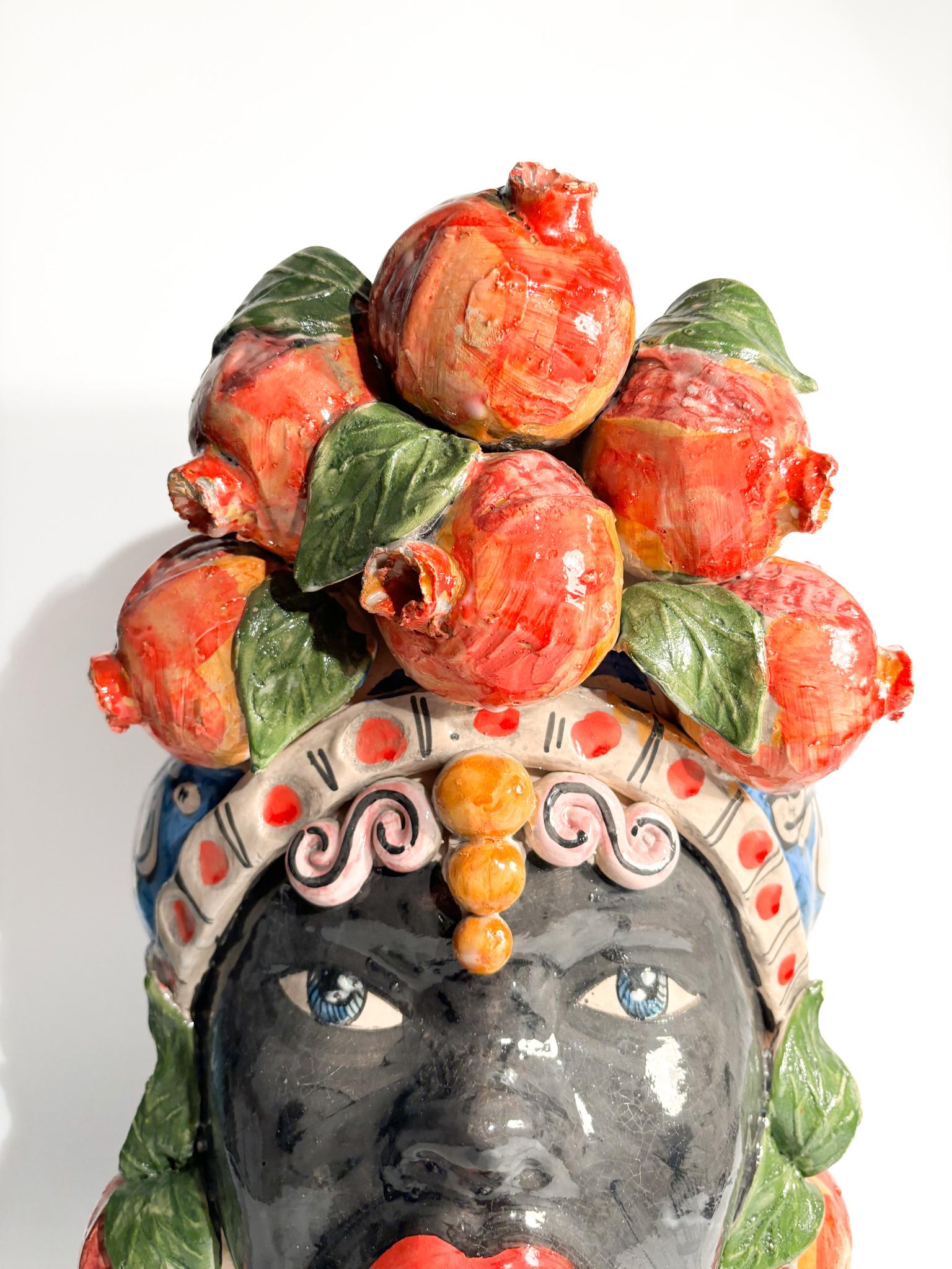 Moor's head of Caltagirone of a female figure with pomegranates, made by Ceramiche Germano in the 1990s

Ø 26 cm h 46 cm

Ceramiche Germano is a ceramic company based in Caltagirone, Sicily, Italy. The company was founded in 1967 by Sebastiano