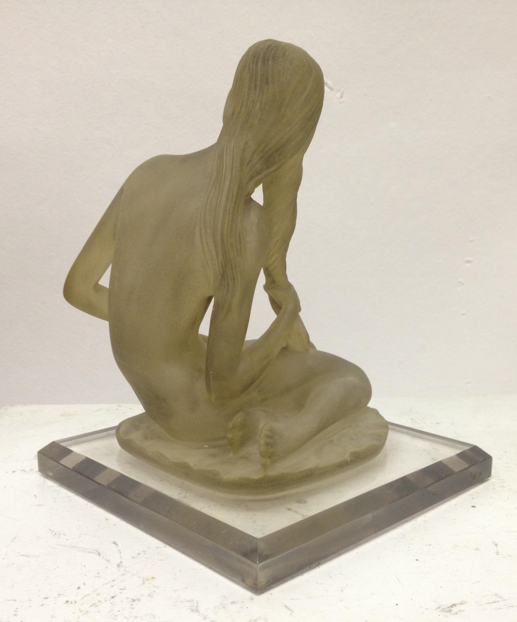 Inspired by classical antiquity, this sculpture of a female nude is skilfully rendered in cast resin. The label underneath reads 