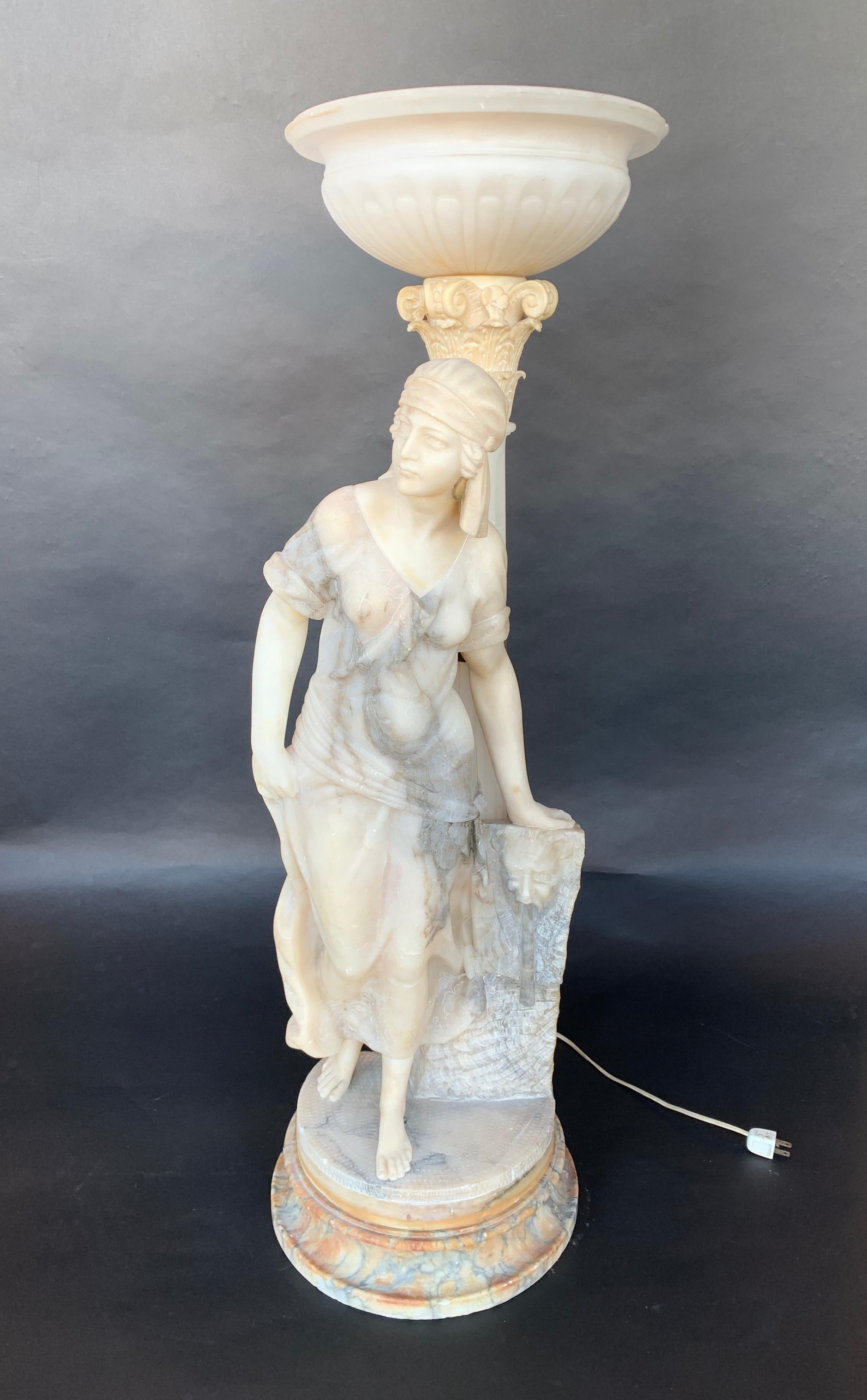 Sculptural torchère lamp of a woman, made of marble and alabaster.