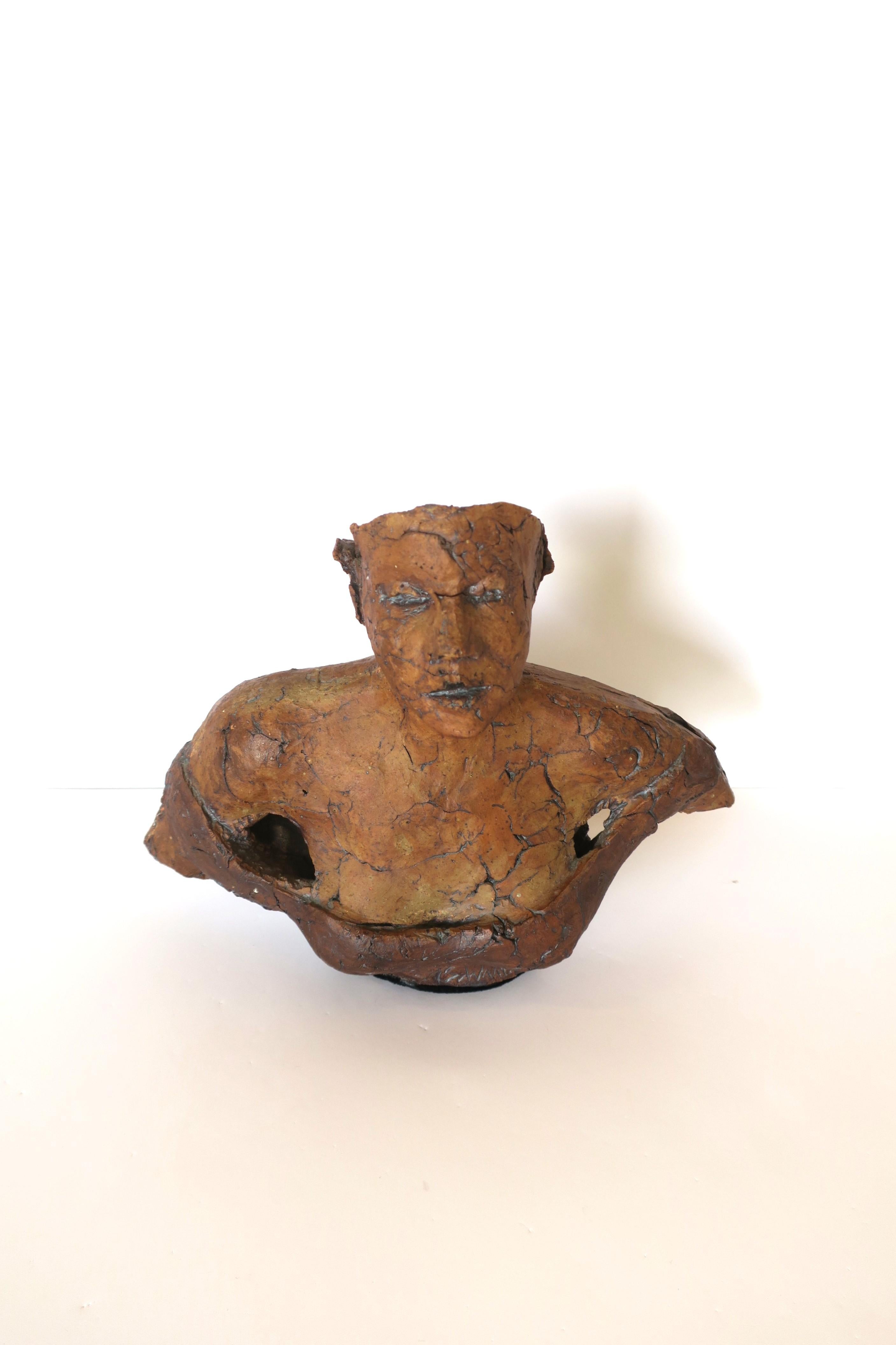 A female terracotta bust sculpture. Great as a standalone piece, on a pedestal, shelf, etc. Signature at base as shown in last image. Dimensions: 4