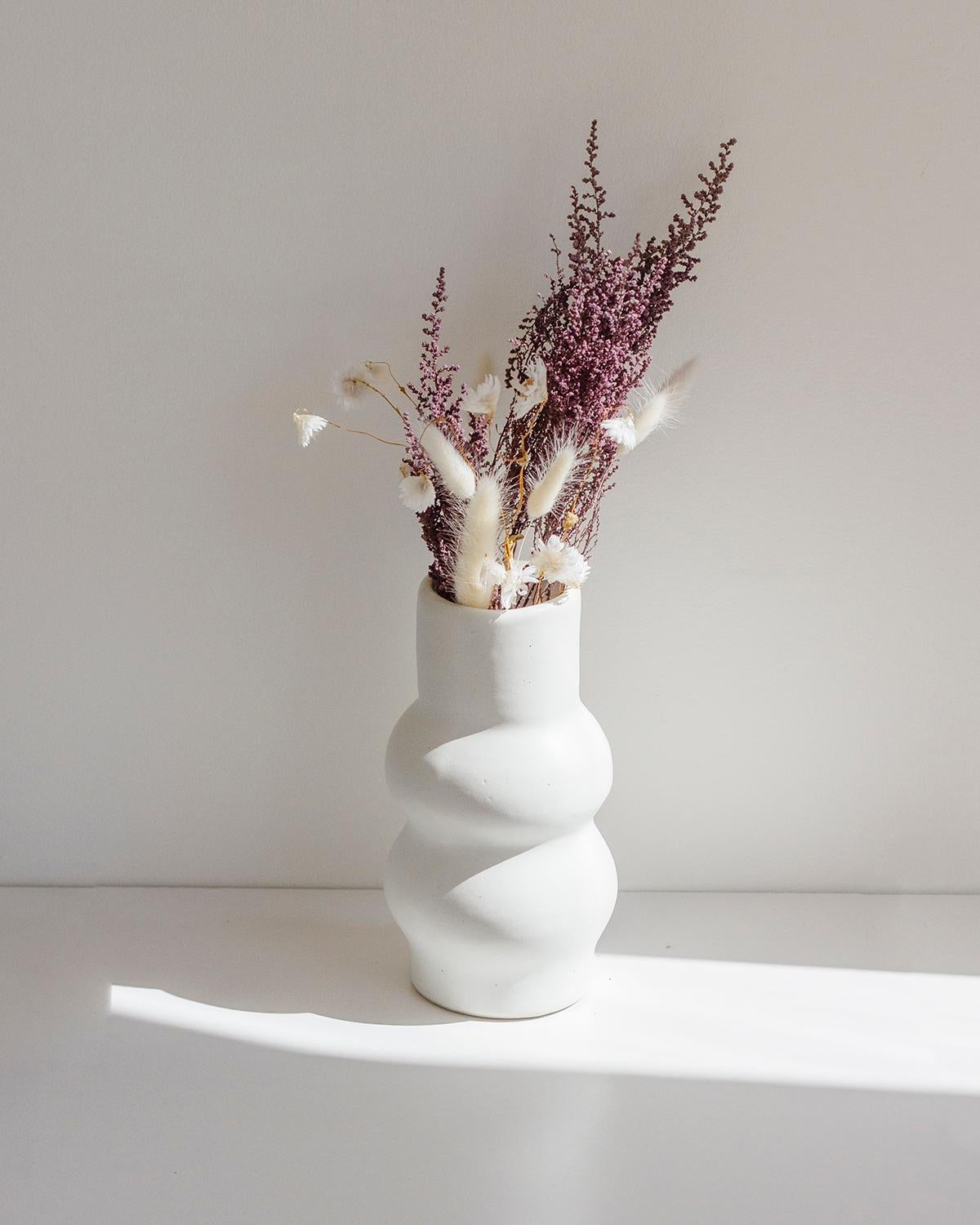 This uniquely beautiful clay vase was designed by Camila Apaez, and hand-made by her women-lead artisan studio in Guadalajara, Mexico.

This design is also available in brown.

Only one of each design and color available. Each one of these vases