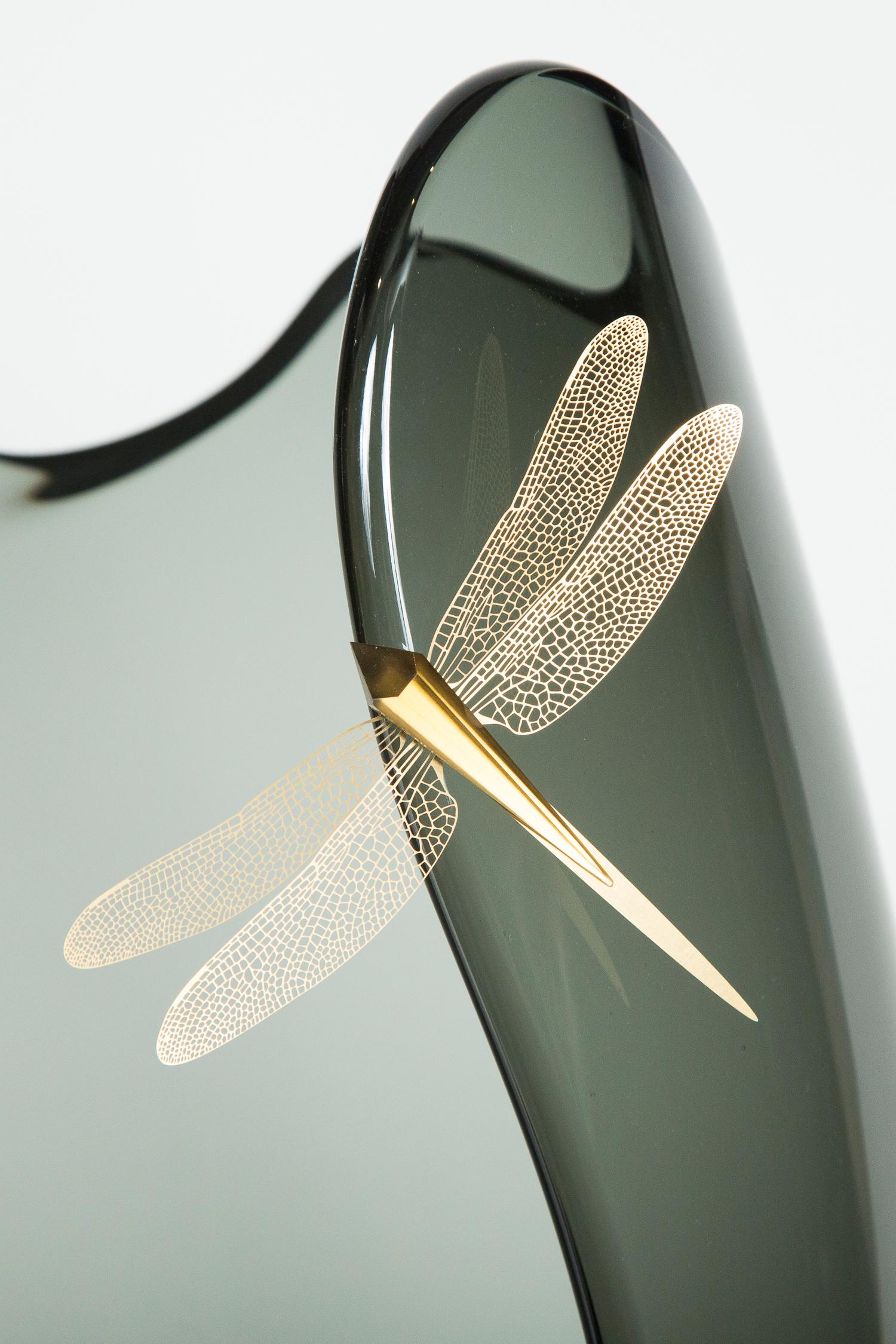 Fen III is a unique glass and gold plated steel sculpture by the Danish artist Hanne Enemark. The glass body has been hand-blown and painstakingly cut to create dramatic and sweeping curves that traverse its soft-edged rim. Each dragonfly is made