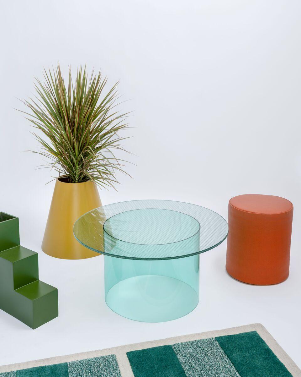 As part of the Court series, the track table debuted at the International contemporary Furniture Fair in 2018.

Glass surface with metal mesh interlayer. 
Acrylic cylinder base in mint. 
Made in USA.