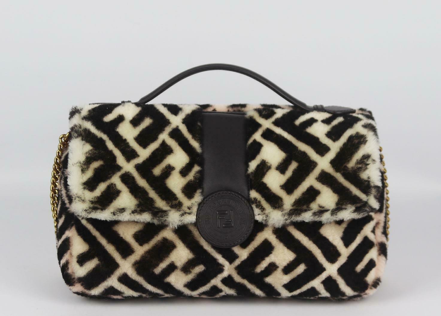 This stunning '1974 Double F' shoulder bag by Fendi bag has been made in Italy from plush shearling fur and printed with the iconic logo, the bag has two-sides, one light-pink and the other beige, it's fastening opens to reveal a beige interior