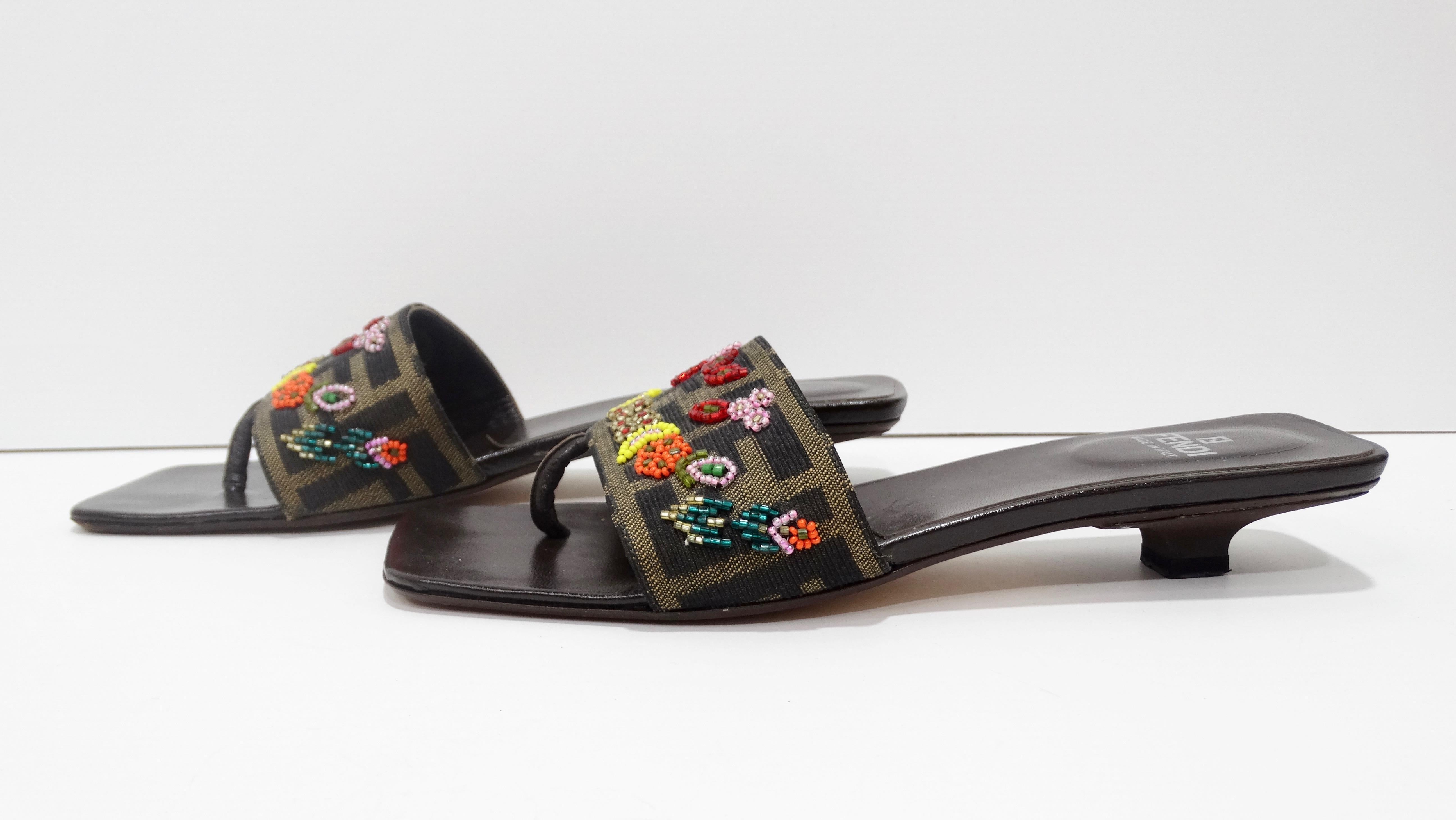 Your perfect Zucca shoe is here! Circa 1990s, these Fendi sandals feature a kitten heel, a leather insole and the iconic Zucca print with floral beading on top. Soles are stamped Made in Italy and are marked a size 7. The ultimate summer shoe, these