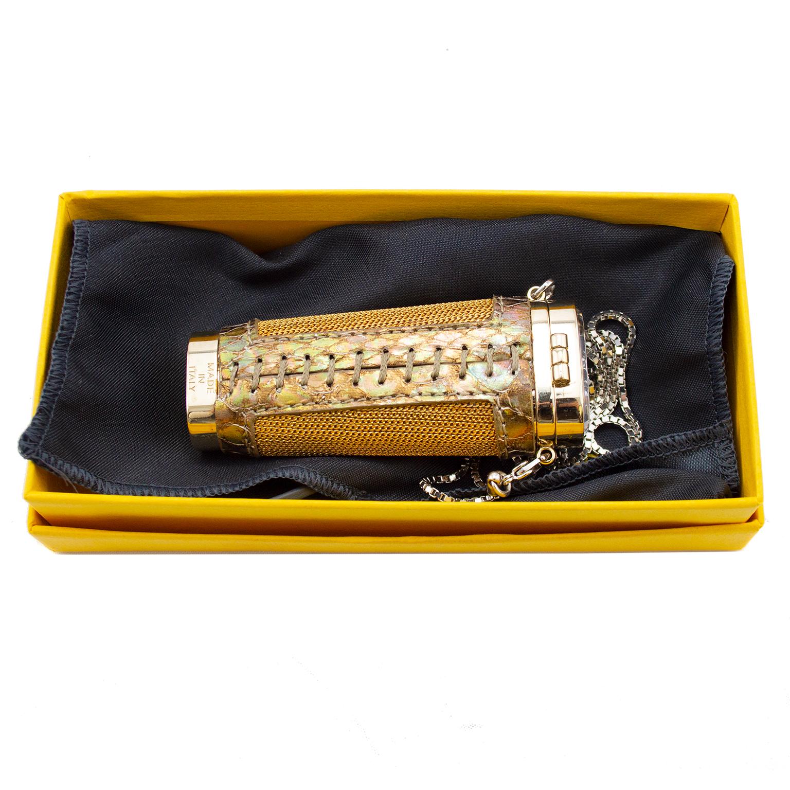 Novelty Fendi mid 1990's hanging chain necklace with hard case object holder. It appears to have been designed to hold a disposable cigarette lighter. Gilded metal chain mail detail around the sides with stamped hard flip top and slightly tapered