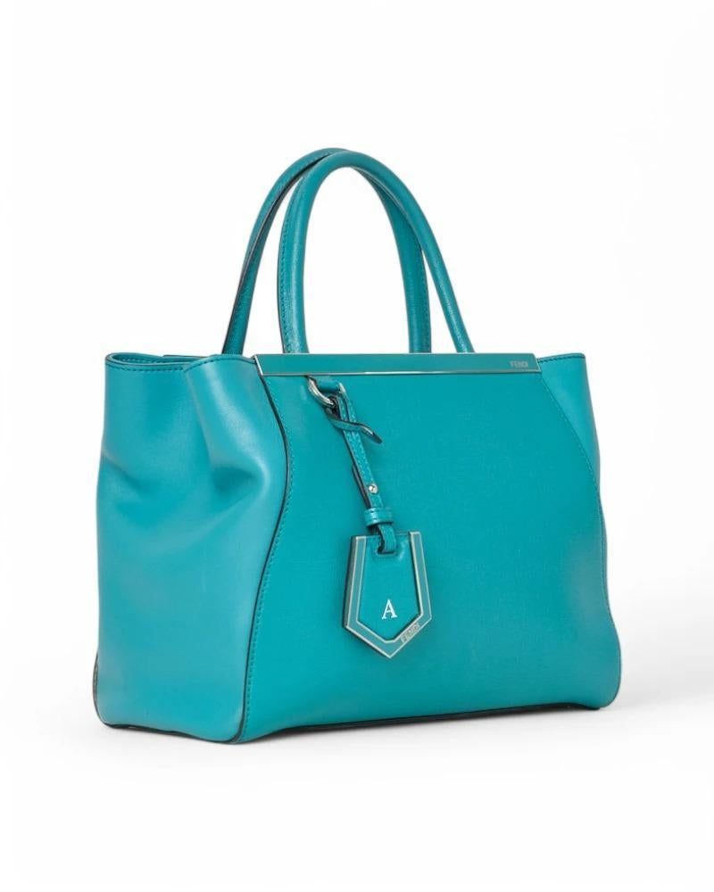 Fendi signature bag, model 2 Jours in size Small, made of leather in the sophisticated turquoise color with silver hardware. Featuring a central clip closure, internally lined in tone-on-tone logo fabric with two convenient compartments and a