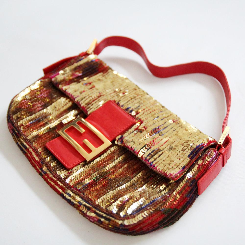 FENDI

2000s. Extremely rare baguette bag with double-sided reversible sequins.
From one angle it looks gold, from the other you see a red, purple, gold diamond pattern.

Buy Now Or Cry Later! 

- Lining: red leather and pink fabric
- with first-set