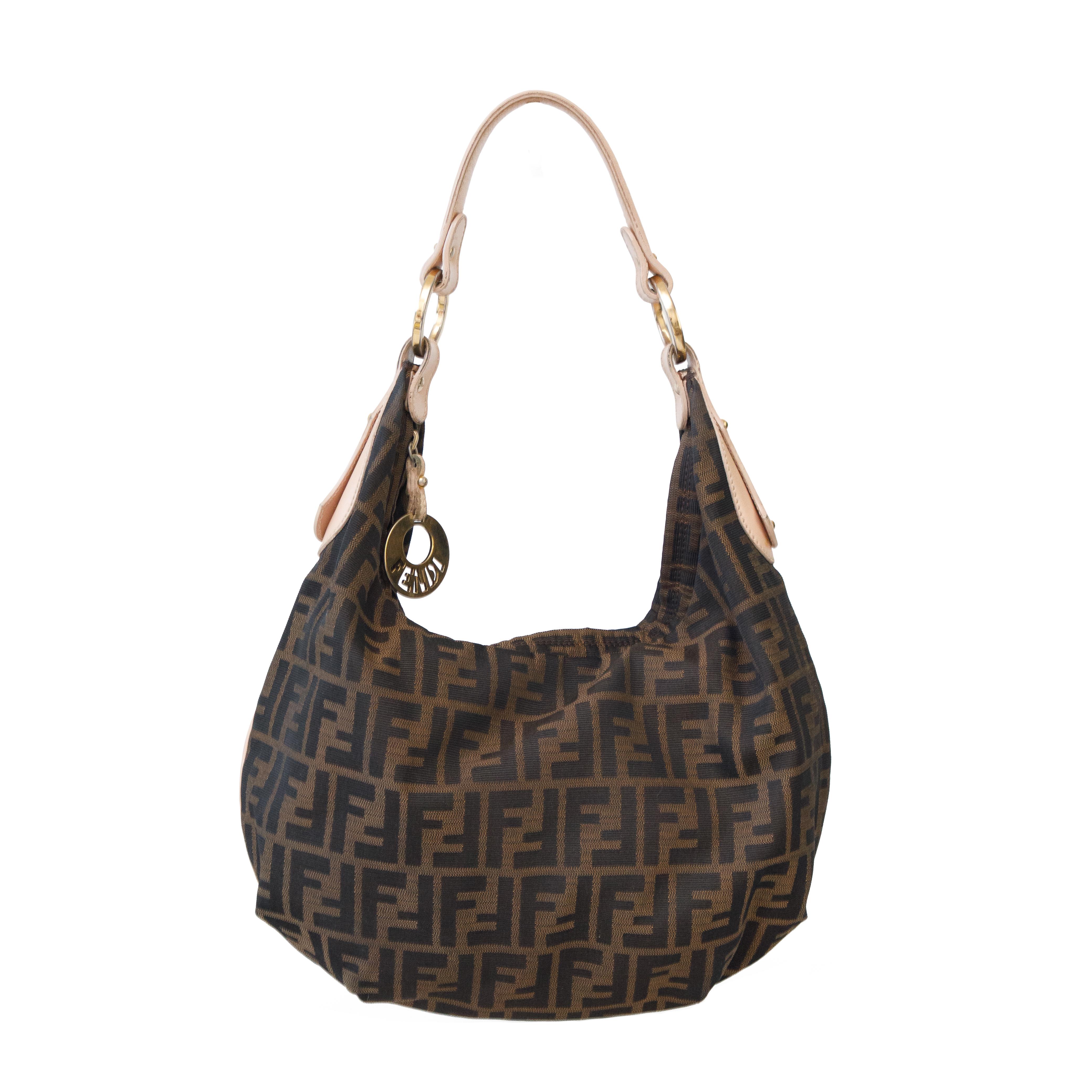 Ruder Than The Rest presents a vintage Fendi zucca monogram hobo handbag.

Slouchy canvas style with dusty pink leather handle.

Gold toned hardware.

Made in Italy.

Vintage, circa 2000s.

Authenticity guaranteed.

Condition: Very good, few signs