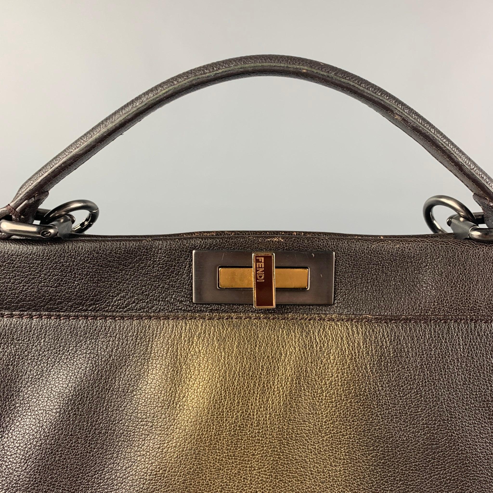 FENID 'Large Zucca Peekaboo'
 2009 bag comes in a brown & gold ombre leather featuring a top handles, detachable shoulder strap, dual compartment, monogram print interior, and a push open closure.
Very Good
Pre-Owned Condition. 

Marked:  