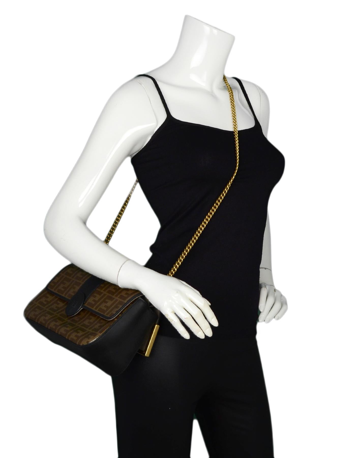 Fendi 2018 Black/Brown Leather/Coated Canvas Monogram Double Flap FF Shoulder/Crossbody Bag

Made In: Italy
Year of Production: 2018
Color: Black/brown
Hardware: Goldtone
Materials: Leather, coated canvas, metal
Lining: Taupe suede
Closure/Opening:
