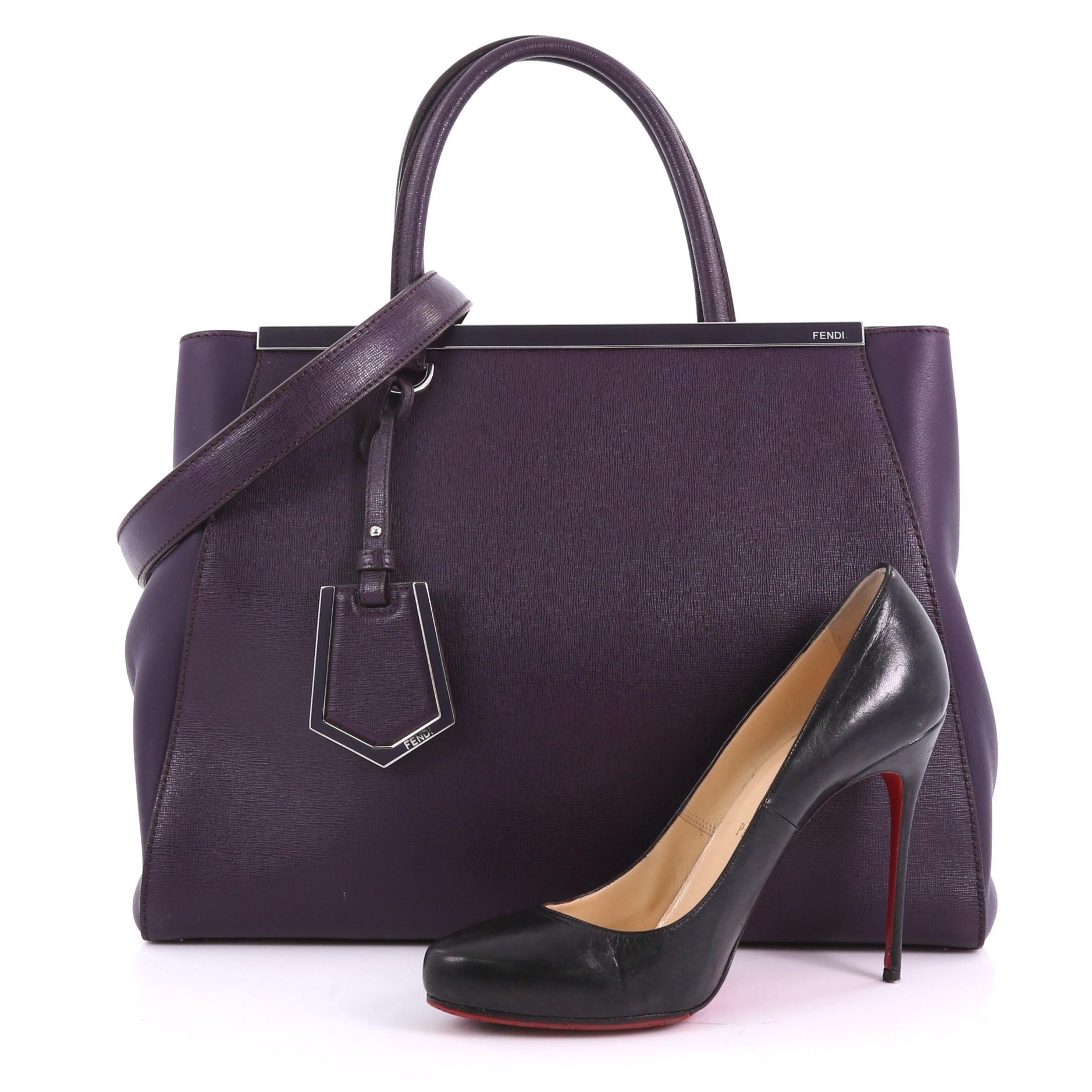 This Fendi 2Jours Handbag Leather Large, crafted in purple leather, features dual rolled leather handles, expanded wings, protective base studs and silver-tone hardware. Its magnetic snap closure opens to a purple fabric interior with zip and slip