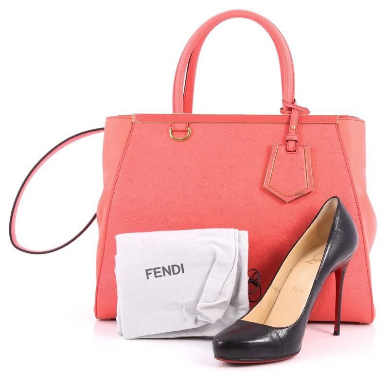 This authentic Fendi 2Jours Handbag Leather Medium is impeccably stylish with a simple silhouette and structured design. Finely crafted in pink leather with soft calfskin sides, this popular tote features a shining top bar that dons the Fendi brand