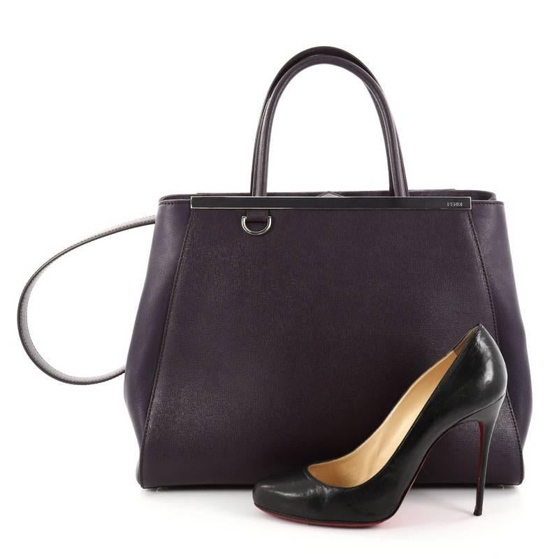 This authentic Fendi 2Jours Handbag Leather Medium is impeccably stylish with a simple silhouette and structured design. Finely crafted in sturdy purple leather with soft calfskin sides, this popular tote features a shining top bar, protective base