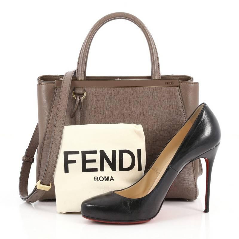 This authentic Fendi 2Jours Handbag Leather Petite is impeccably stylish with its simple silhouette. Crafted from brown leather, this chic tote features dual-rolled leather handles, a shining top bar with the Fendi brand name, protective base studs,