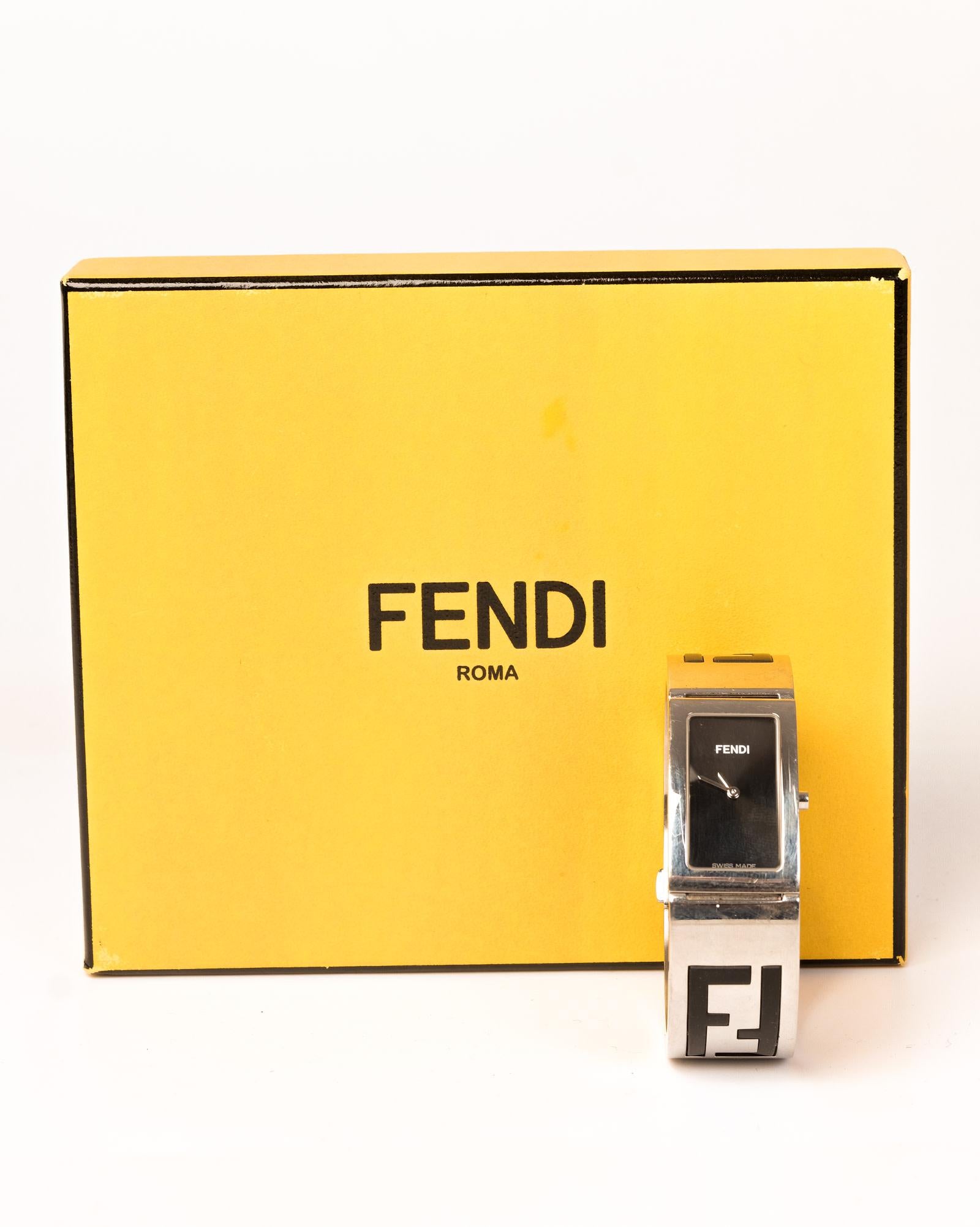 Stainless steel 20 x 32mm Fendi Bangle Bracelet Watch with quartz movement, sapphire crystal, smooth bezel, flat black dial, stick hands, push/pull crown, stainless steel bracelet with rubber Zucca inlays and push-lock closure. Includes box.

COLOR: