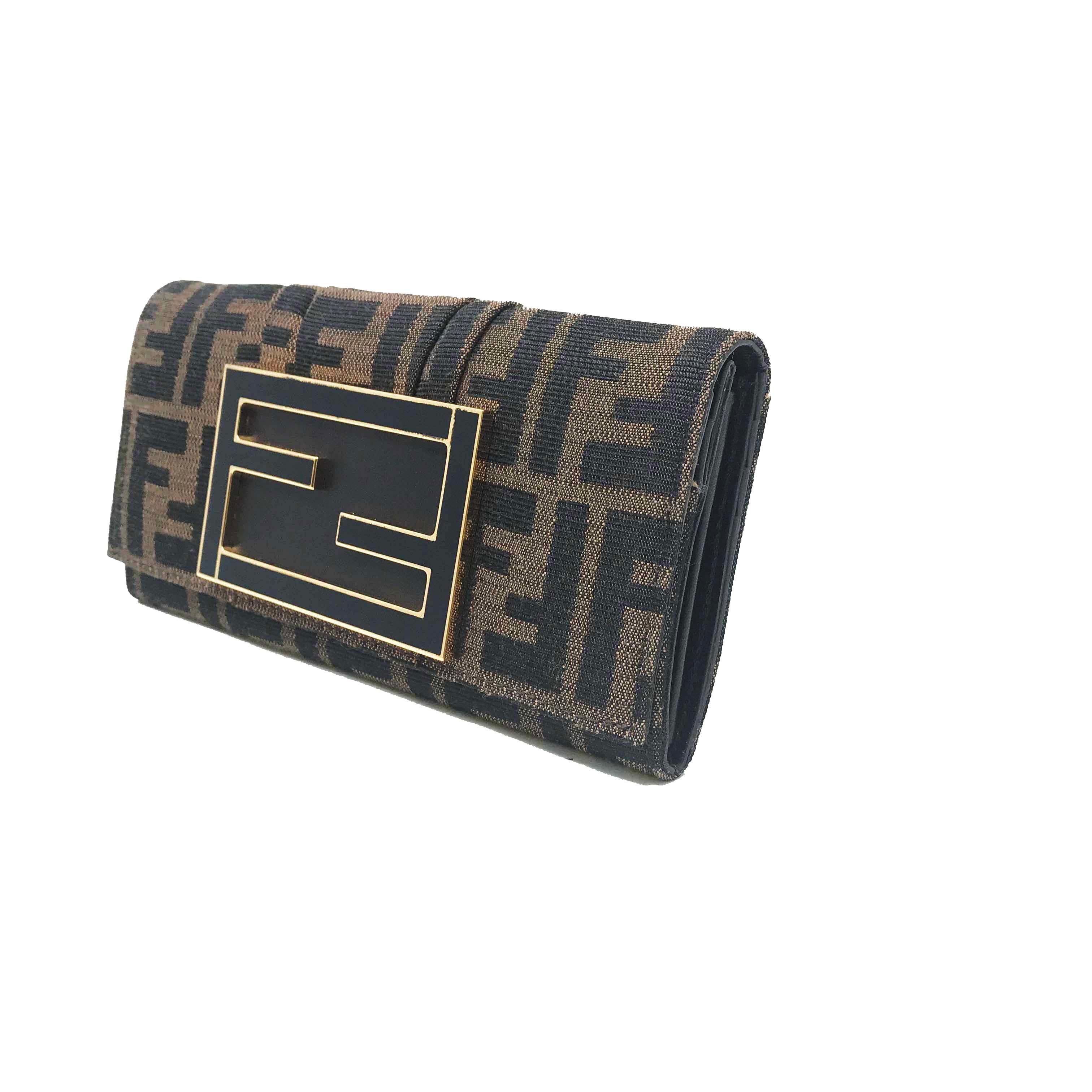 We guarantee this is an authentic FENDI Zucca Mia Clutch Wallet Tobacco or 100% of your money back. This stunning clutch is crafted of Fendi Zucca monogram canvas. The bag features a frontal Fendi FF brass embellishment and opens to a partitioned