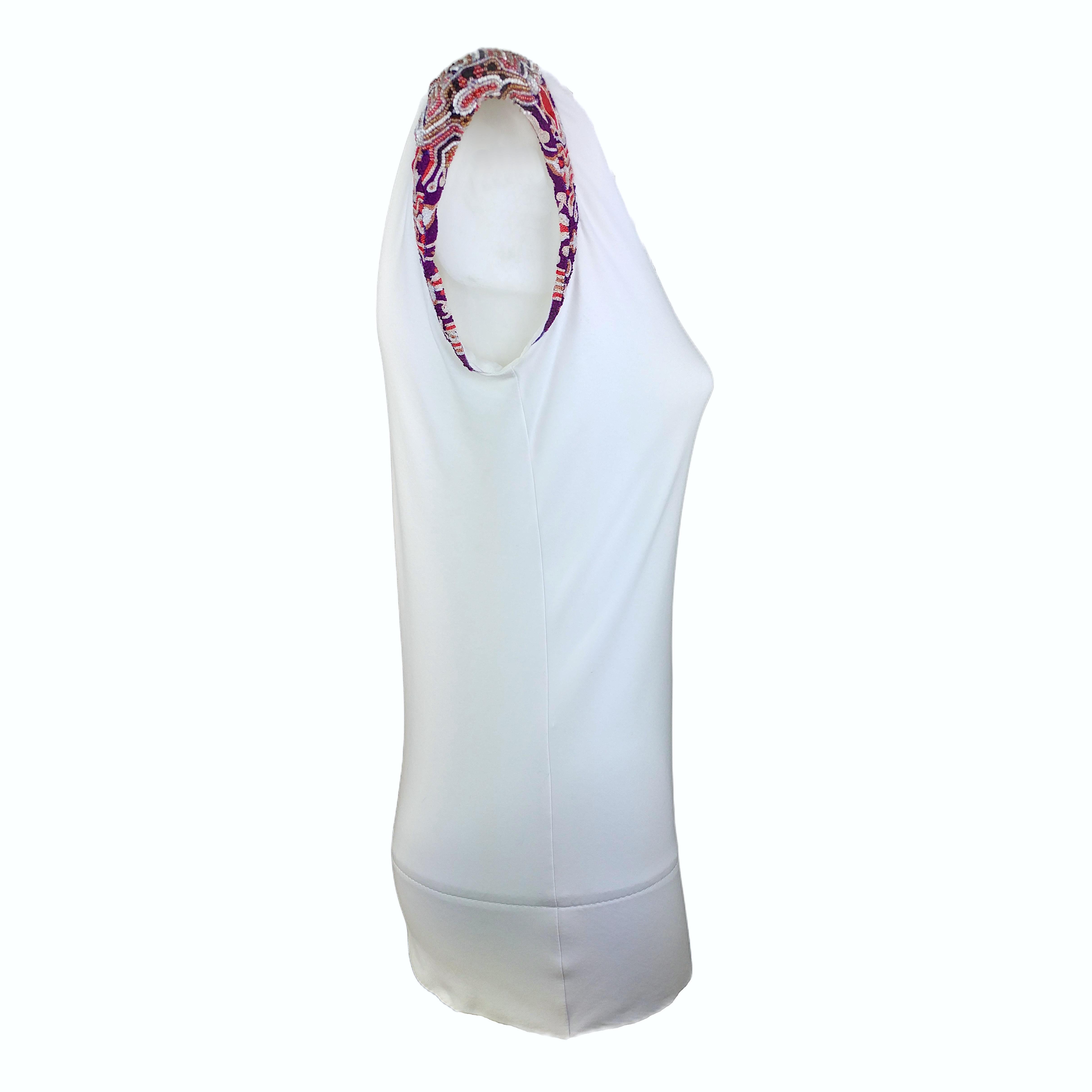 Here's a Genuine Fendi White Top from the early years 2000, designed by Carla Fendi. It has a mock neckline and shoulder pads 1.5 cm high. The shoulders are completely covered by a refined arabesque pattern made of beads.

About the brand - An