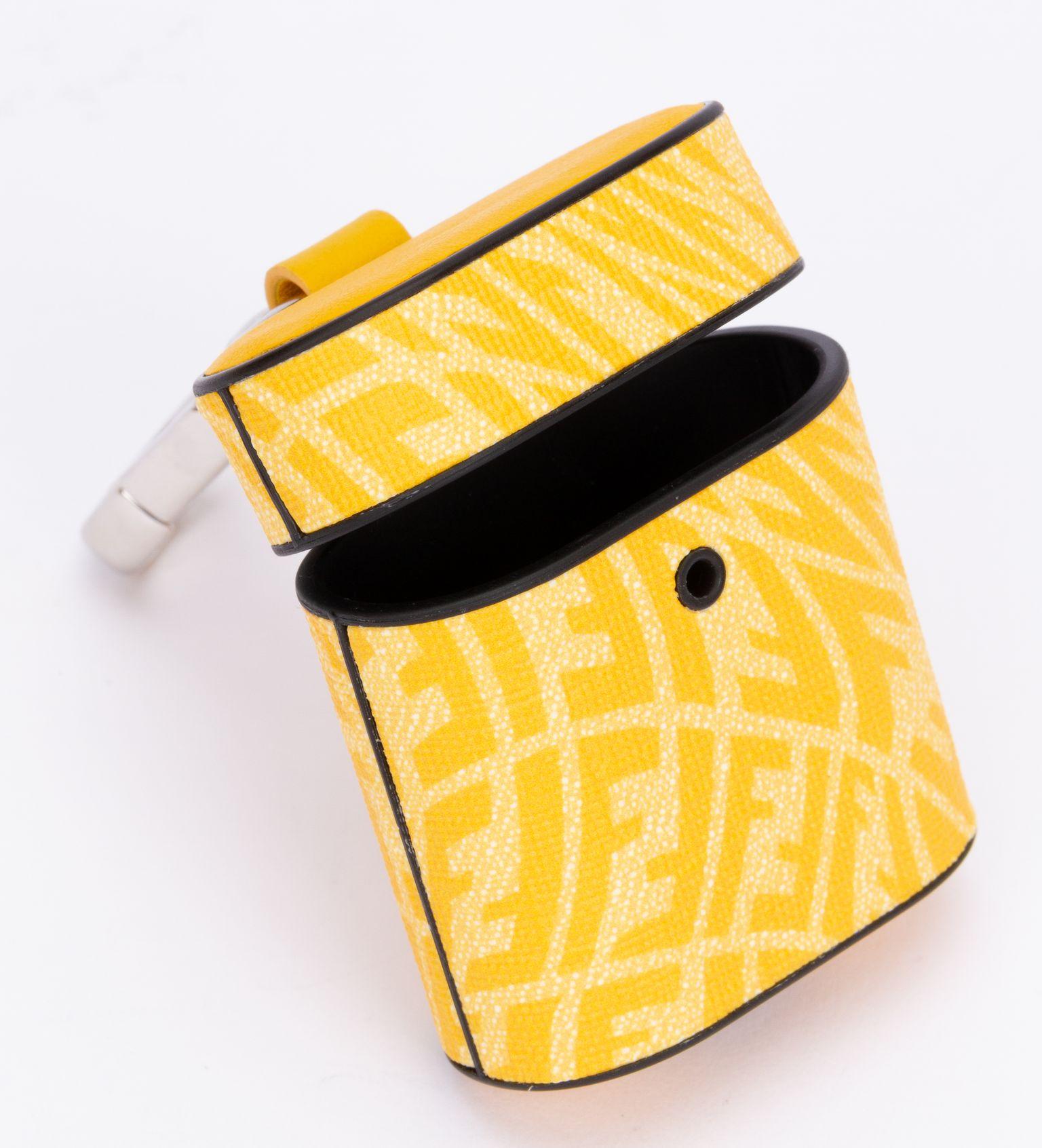 Fendi air pods charm to attach to a bag. This piece can clip on all different sizes of bags. It has a zip so it's perfect to store stuff. The charm comes in a vibrant vertigo yellow print. It is brand new and comes with the booklet, original box and