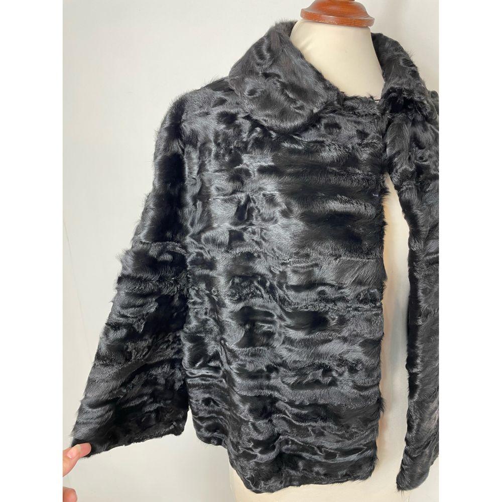 Fendi Astrakhan Short Vest in Black

Fendi black astrakhan cape. Closure with a small button under the collar. In two places on the collar there is a slight lack of hair as can be seen from the photos but otherwise in perfect condition. 
The size is