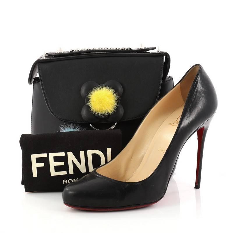 This authentic Fendi Back to School Backpack Pom Pom Leather Mini is a stylish and gorgeous bag perfect for the modern fashionista. Crafted in black leather, this chic bag features sliding curb chain and leather strap can be worn as crossbody strap