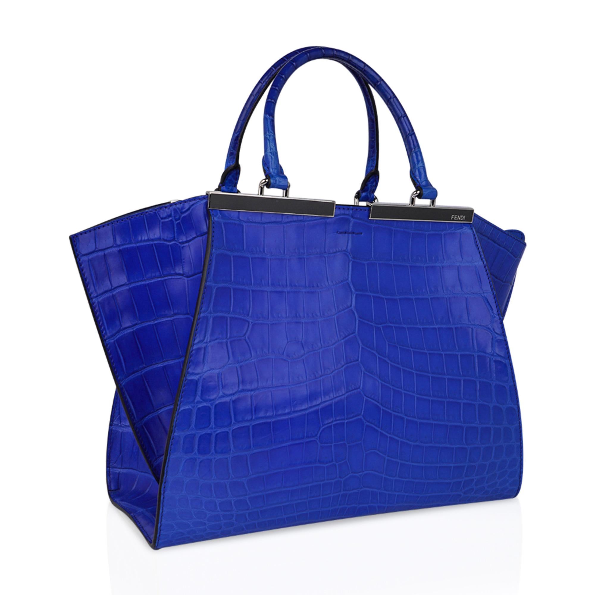 Mightychic offers a Fendi 3Jours Medium Blue Matte Crocodile Bag.
A rich and striking electric Blue matte crocodile tote with silver toned hardware.
Double handle with top zip closure.
Bag comes with a Blue matte crocodile clochette housing a silver
