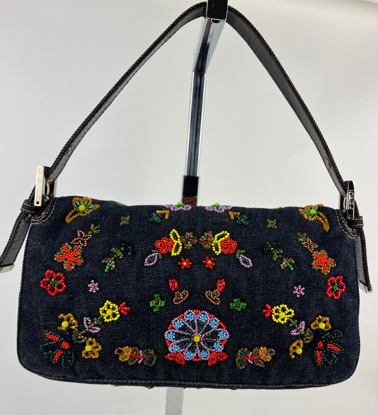 Pre-Owned  100% Authentic
FENDI Ricami Beaded Baguette Blue Denim Bag
RATING: A/B...Very Good, well maintained,
shows minor signs of wear
MATERIAL: denim, leather
HANDLE:  adjustable leather denim strap 21'' long
DROP: 6'' to 7''
COLOR:  red, blue,