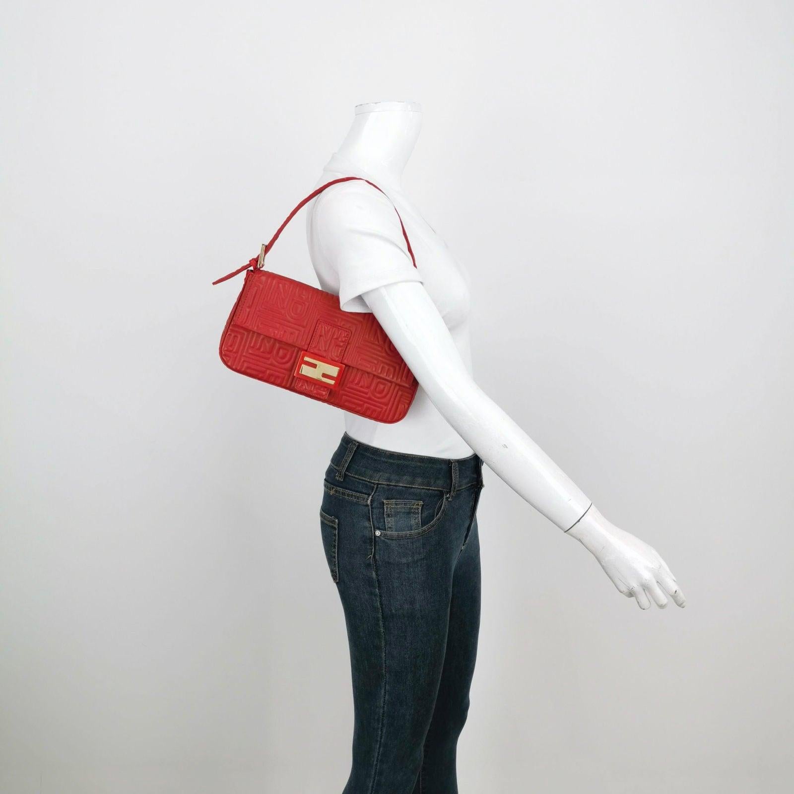 Fendi Baguette 1997 Re-edition 3D Embossed Red Leather Shoulder bag These are professional photos of the actual bag offered by Luxbags. Experience a modern twist on a timeless classic with the Fendi Baguette 1997 Re-edition shoulder bag. Crafted