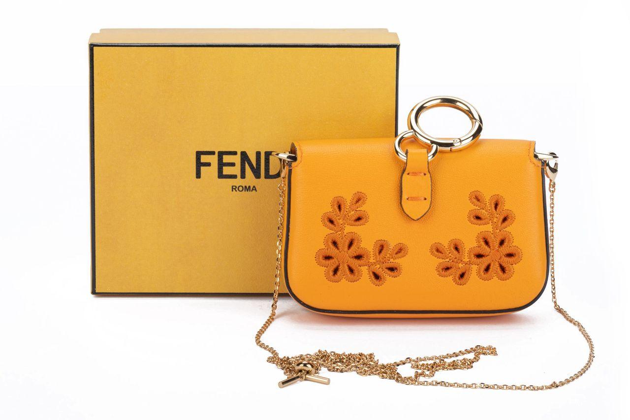 Fendi baguette charm with floral embroidered leather. This nano baguette come in the color clementine. The hardware is gold and it comes with an adjustable and detachable chain (22