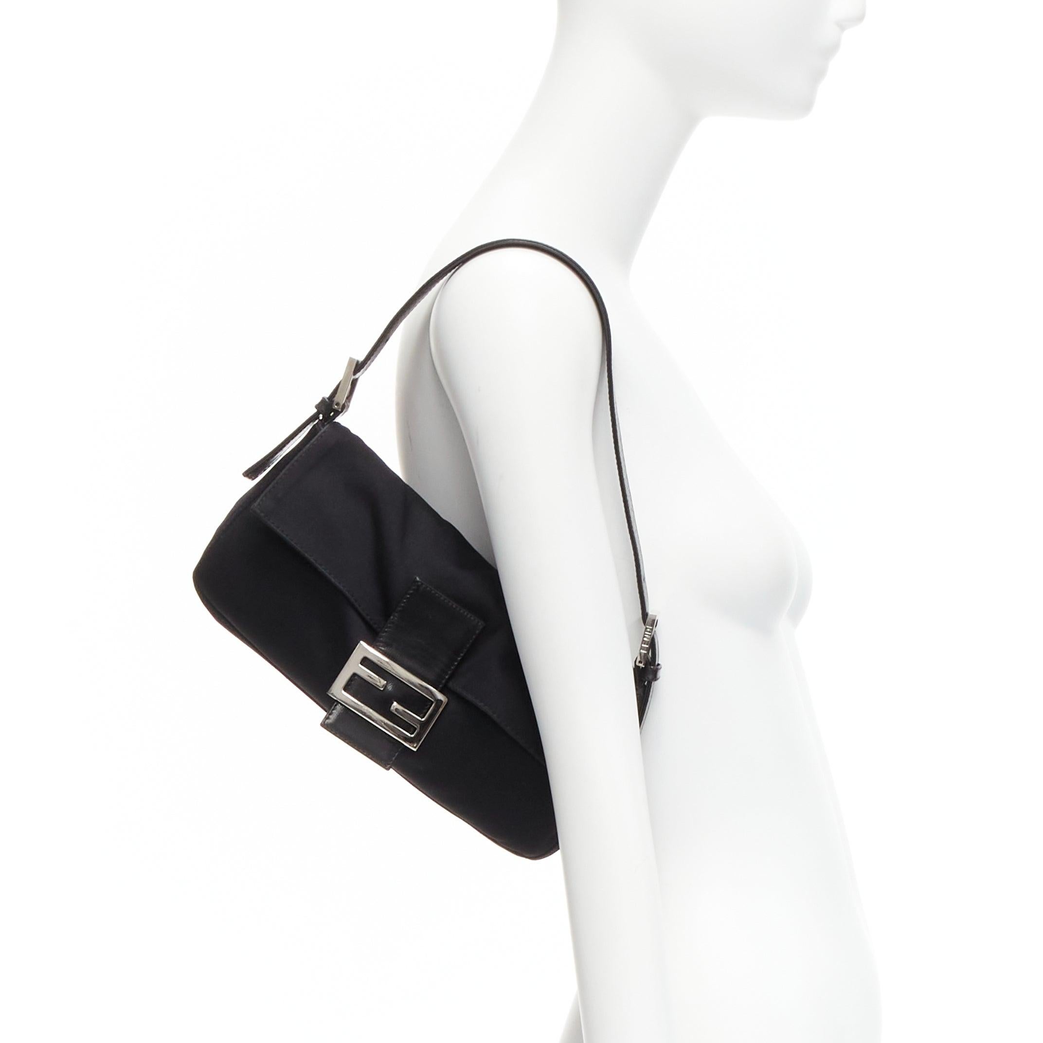 FENDI Baguette black fabric leather strap metal buckle underarm bag
Reference: TGAS/D00581
Brand: Fendi
Model: Baguette
Material: Fabric, Leather
Color: Black, Silver
Pattern: Solid
Closure: Snap Buttons
Lining: Black Fabric
Extra Details: Plain