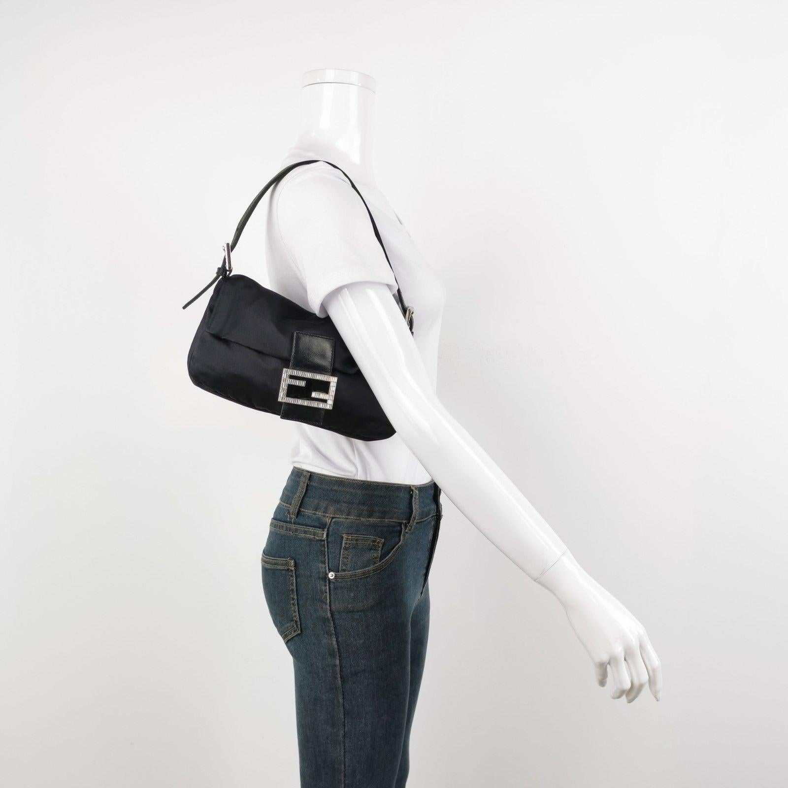 FENDI Baguette Black Silk Satin with Crystal Buckle Shoulder Bag These are professional photos of the actual bag offered by Luxbags. Introducing the timelessly elegant FENDI Baguette in Black Silk with Crystal Buckle! In very good condition, this