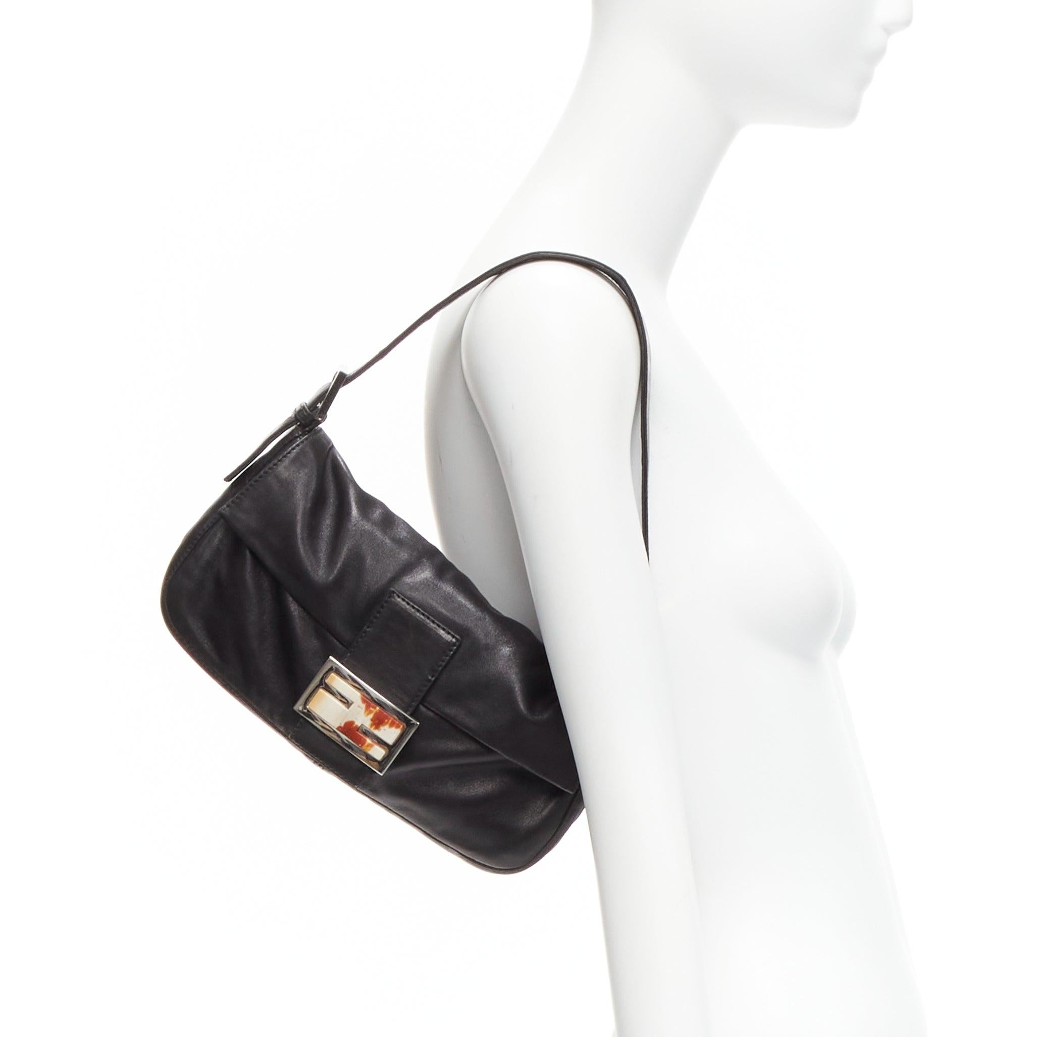 FENDI Baguette black soft nappa leather enamel FF buckle underarm bag
Reference: TGAS/D00804
Brand: Fendi
Model: Baguette
Material: Leather
Color: Black, Multicolour
Pattern: Solid
Closure: Snap Buttons
Lining: Red Fabric
Extra Details: Soft nappa