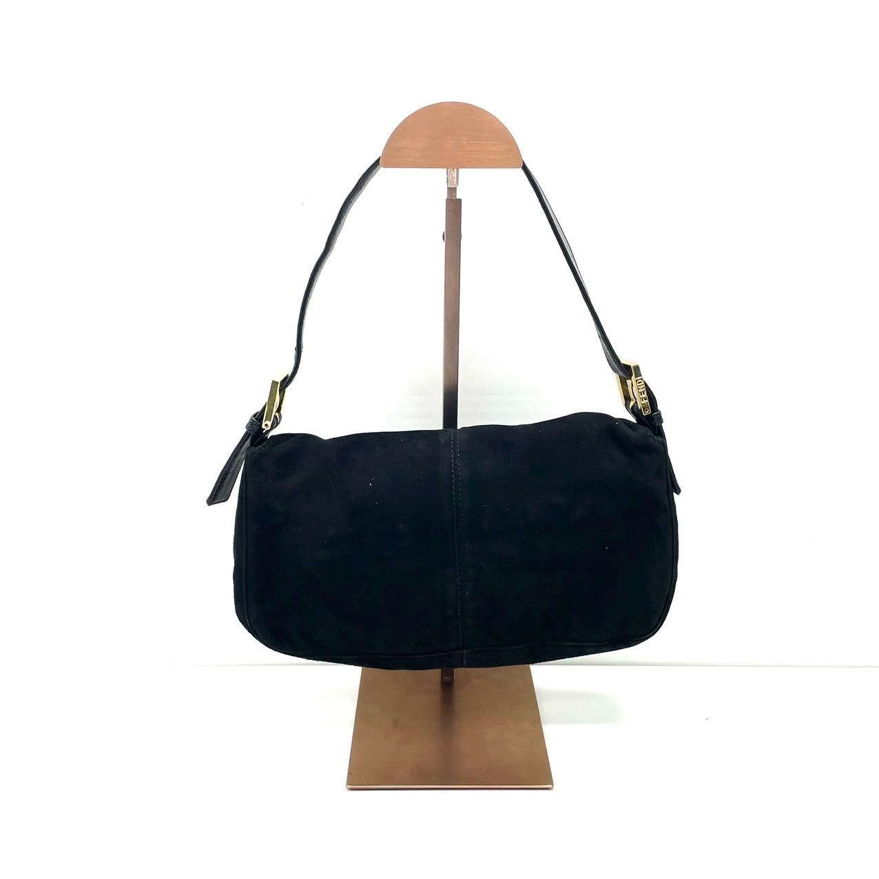 Fendi Baguette Black Suede Leather Red Buckle Shoulder Bag
 These are professional photos of the actual bag.
 EXCELLENT: VERY GOOD
 Rubbing along the corners, edges and strap. 
 DETAILS
 
 
 Model: Fendi Baguette
 
 
 Size: Medium
 
 
 Exterior