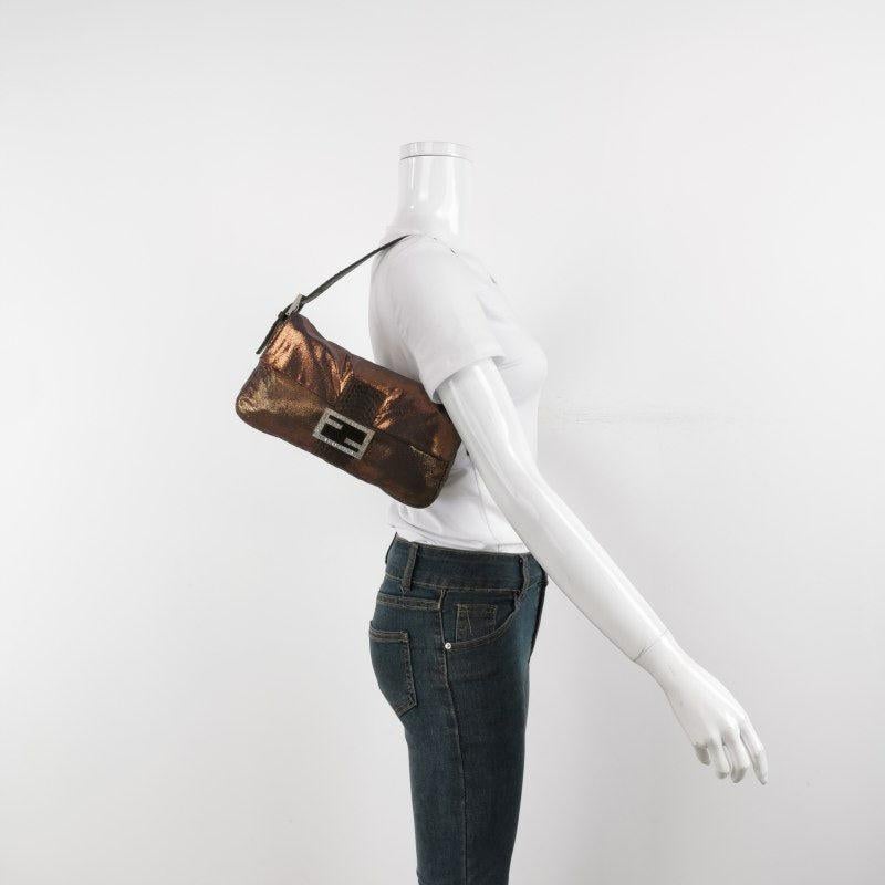 Fendi Baguette Copper Lambskin Leather Crystal Buckle Shoulder Bag
 These are professional photos of the actual bag.
 EXCELLENT: VERY GOOD
 Rubbing along the corners, edges and strap. 
 DETAILS
 
 
 Model: Fendi Baguette
 
 
 Size: Medium
 
 

