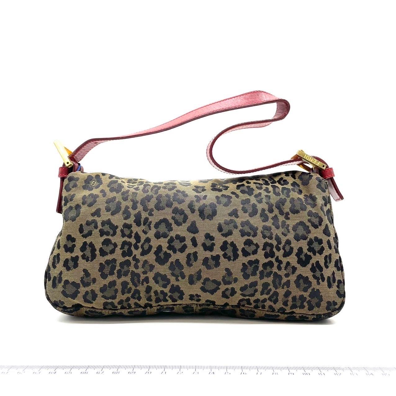 Fendi Baguette Denim Leopard Print with Red Leather Rare
These are professional photos of the actual bag.
  This rare Fendi Baguette combines a wild leopard print, bold red leather and gold-tone hardware for a striking aesthetic. The holy grail