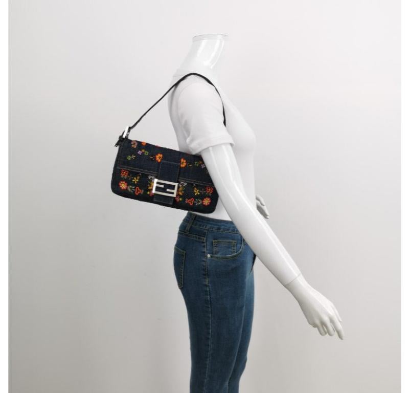 Fendi Baguette Denim with Floral Beads 25 Anniversary Special Collection
These are professional photos of the actual bag.
  CONDITION: NEVER WORN
  DETAILS
  
  Fendi
  Baguette
  Denim
  Yellow satin lining
  Silver hardware
  Standard size
  Width