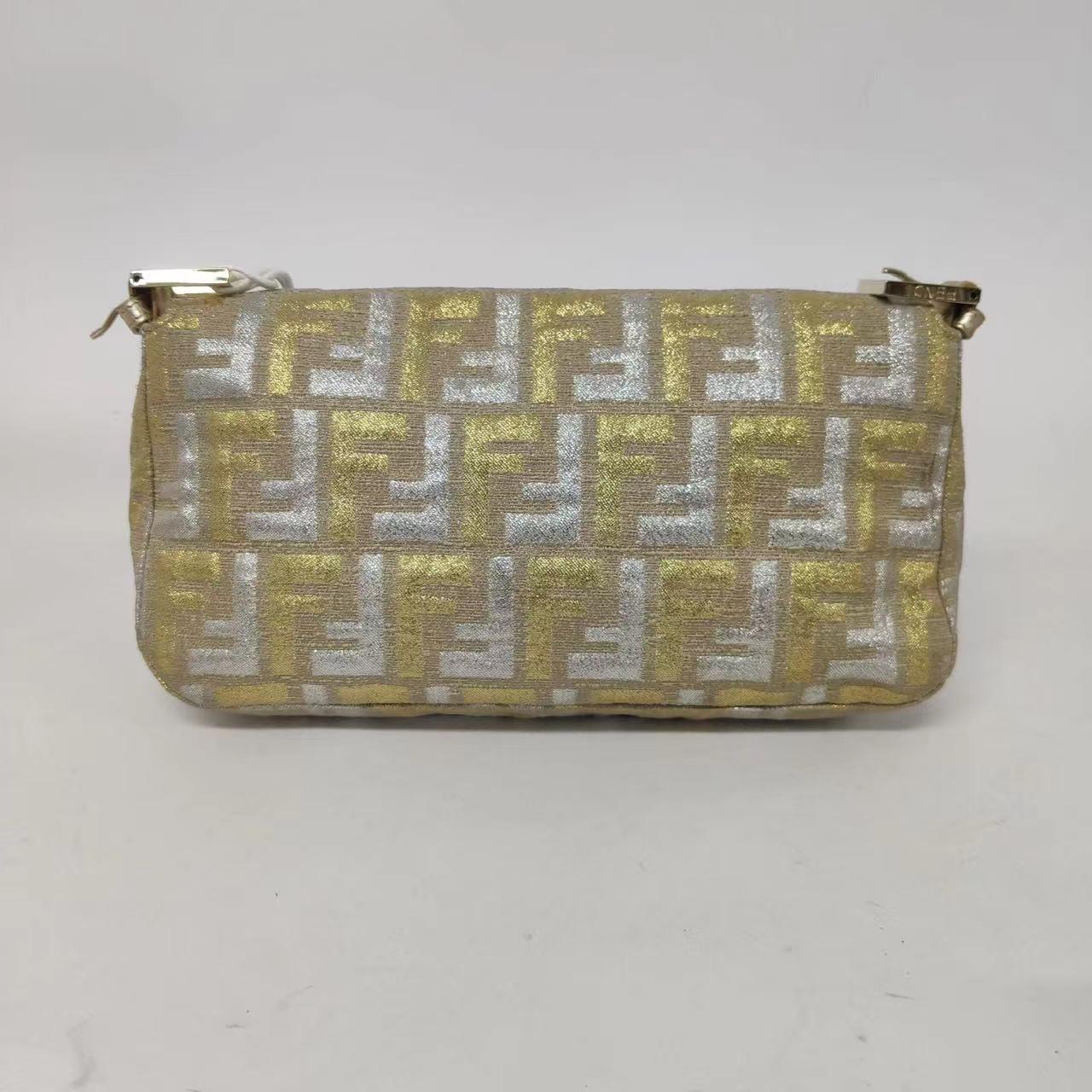 Fendi Baguette Gold and Silver Thread FF Monogram Shoulder Bag
 These are professional photos of the actual bag offered by Luxbags.
 Fendi Baguette Shoulder Bag Gold and Silver Thread FF Monogram
 Overall in very good condition. 
 Model: Fendi