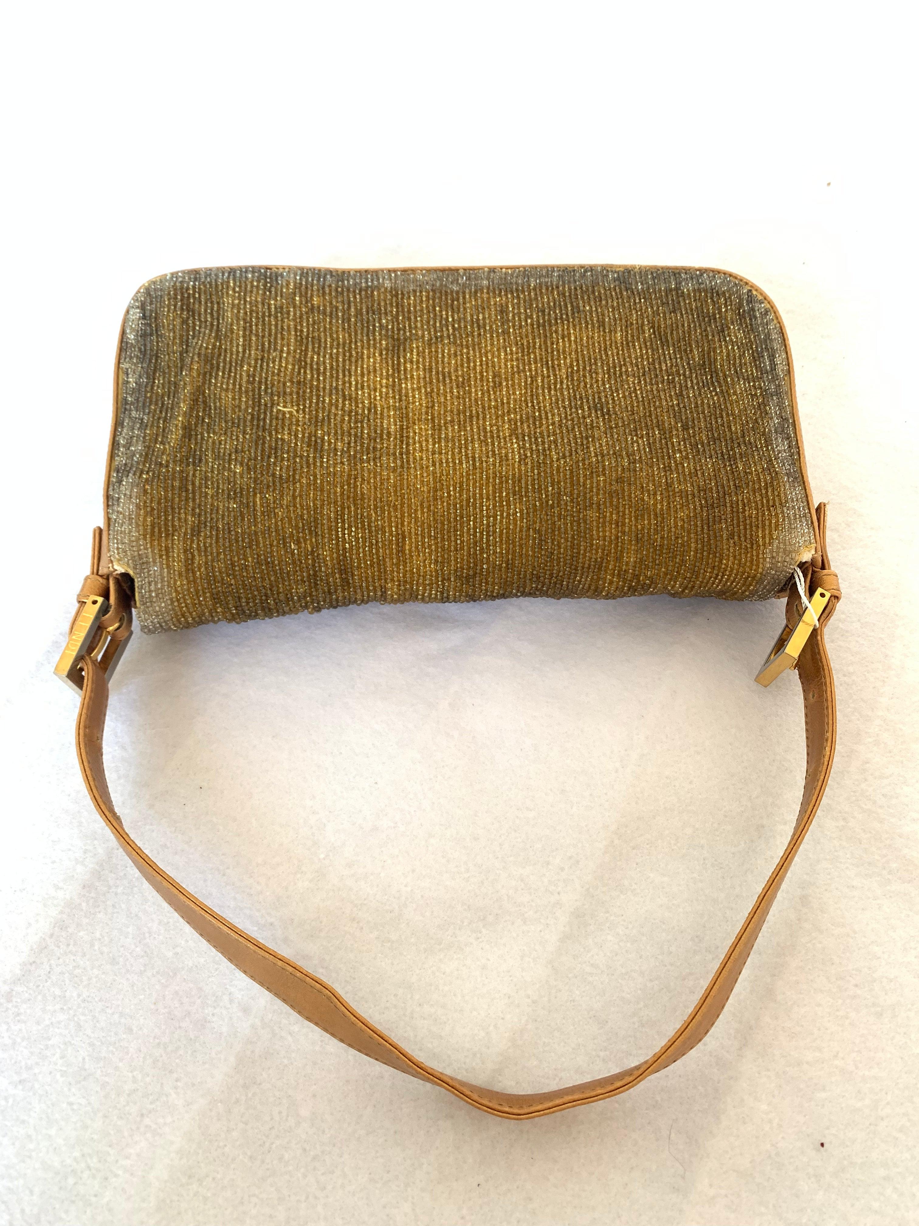 Fendi Baguette in Gold beads and Gold iridescent leather These are professional photos of the actual bag offered by Luxbags. Fendi Baguette in Dark Gold Glitter beads and gold iridescent leather bottom and sides. Lined with canvas interior. Very