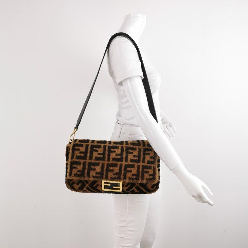 Fendi Baguette Large Shearling Vitello Dolce Marco FF 1974 Tobacco Black Brown Zucca
 These are professional photos of the actual bag.
 Carry it by hand, on the shoulder, or across the body for versatile use. Featuring a top flap with magnetic