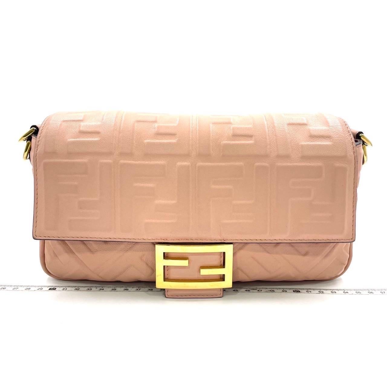 Experience luxury and style with the Fendi Baguette in luxuriously Nappa Leather Crossbody Bag. Crafted from soft nappa leather with intricate 3D FF motif embossing, this incredibly light bag offers both functionality and fashion. Carry it by hand,