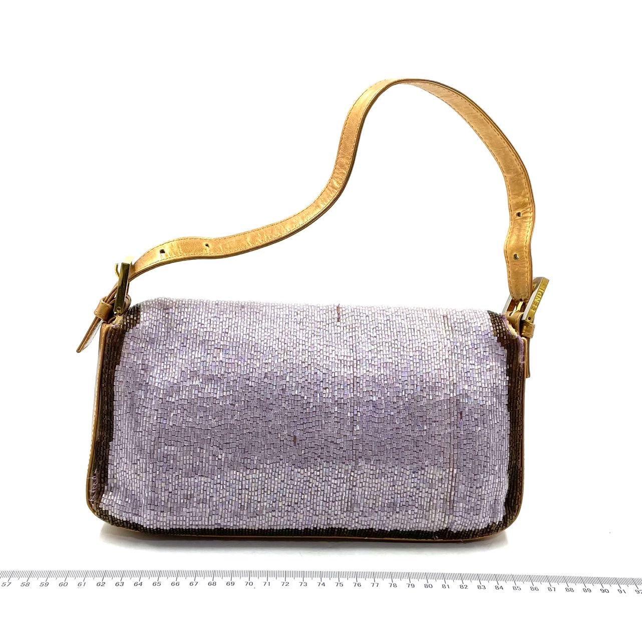 FENDI Baguette Lilac Purple Glitter beads and Gold Leather These are professional photos of the actual bag offered by Luxbags. CONDITION : VERY GOOD This preloved item is in very good condition with signs of use. There may be a couple of missing