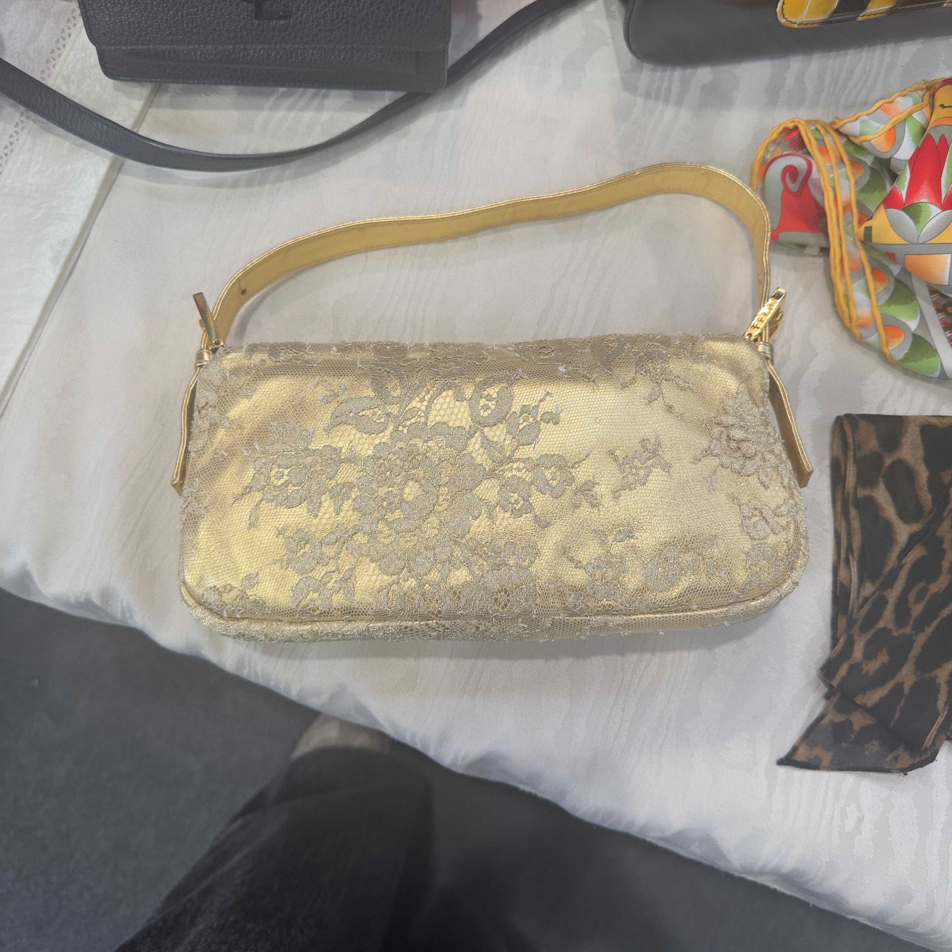 Fendi Baguette ricamata color oro con  fibbia dettagli in pietre. 
Condizioni pari al nuovo, edizione limitata
Manico oro in pelle, interno blu 
Misure 26 x 17 x 5 cm