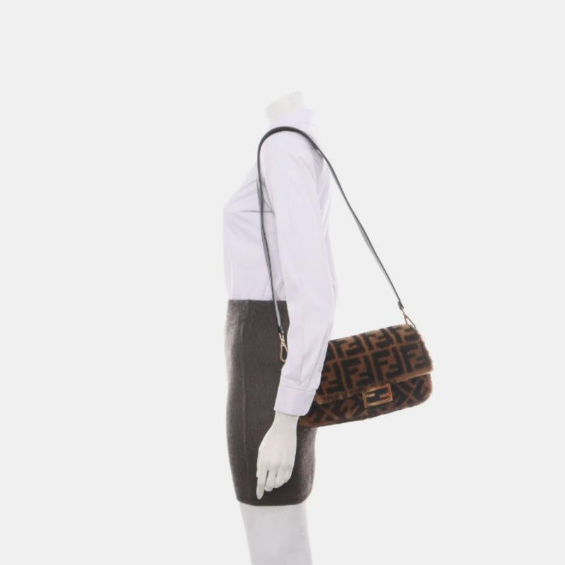 Fendi Baguette Medium Shearling Vitello Dolce Marco FF 1974 Tobacco Black Brown Zucca
 These are professional photos of the actual bag.
 Carry it by hand, on the shoulder, or across the body for versatile use. Featuring a top flap with magnetic