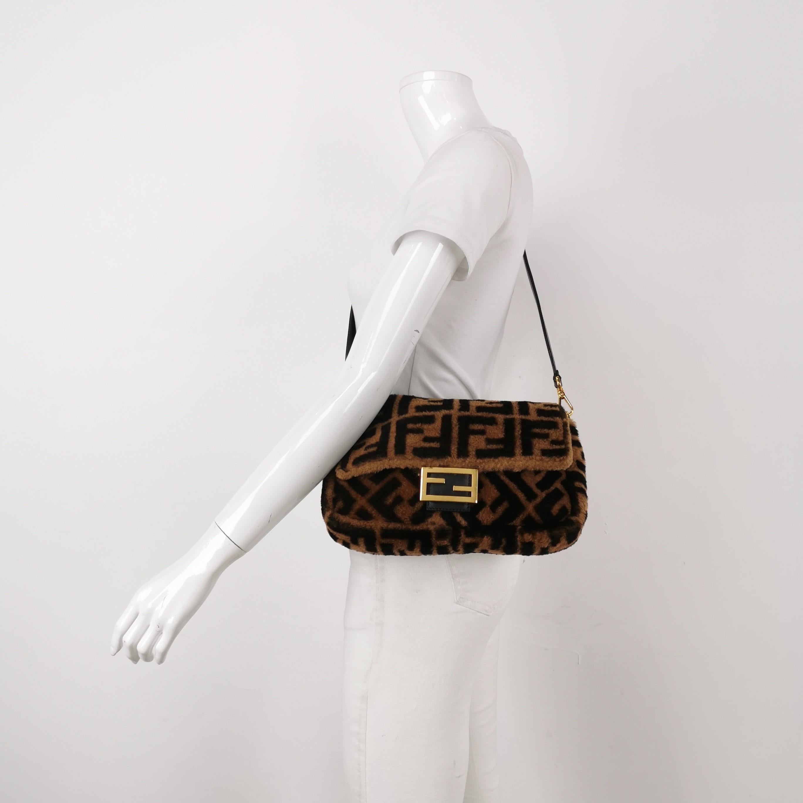 Fendi Baguette Medium Shearling Vitello Dolce Marco FF 1974 Tobacco Black Brown Zucca
 These are professional photos of the actual bag.
 Carry it by hand, on the shoulder, or across the body for versatile use. Featuring a top flap with magnetic