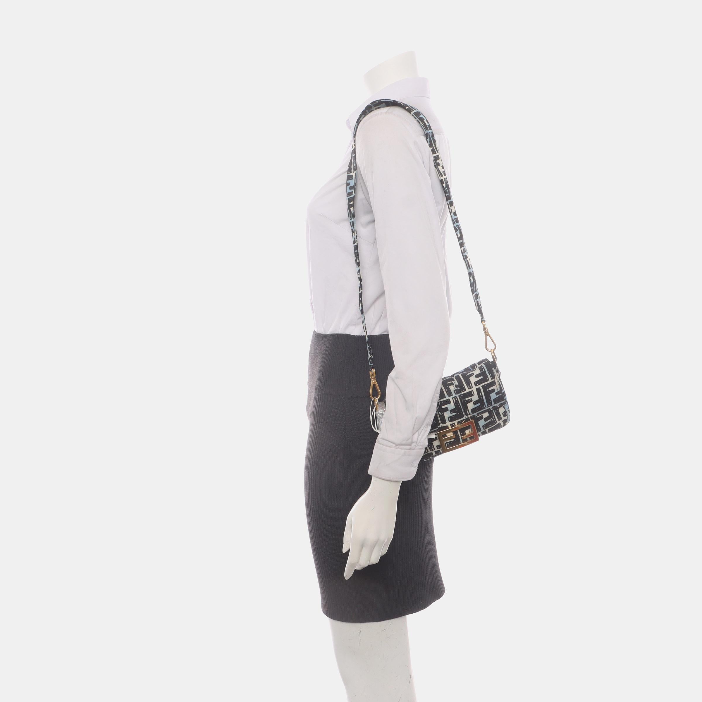 Experience luxury and style with the Fendi Baguette in rare and exquisite silver PVC and leather Crossbody Bag. Crafted from PVC and leather with intricate 3D FF motif embossing created by silver sequins, this incredibly light bag offers both