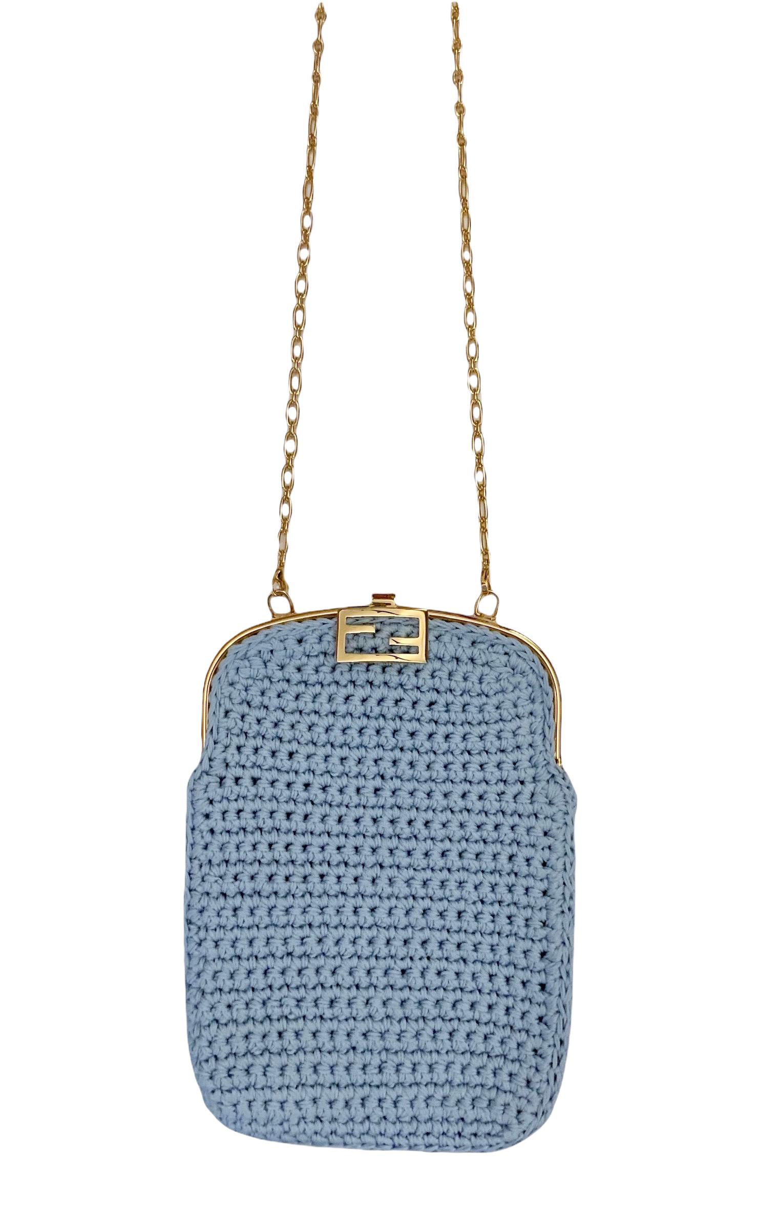 Great mini-bag in a crochet style from the house of Fendi.
It is crafted in light blue cotton and is adorned with the iconic FF Baguette clasp in gold-finish metalware. 
It features one unlined compartment.
It can be carried by hand or worn