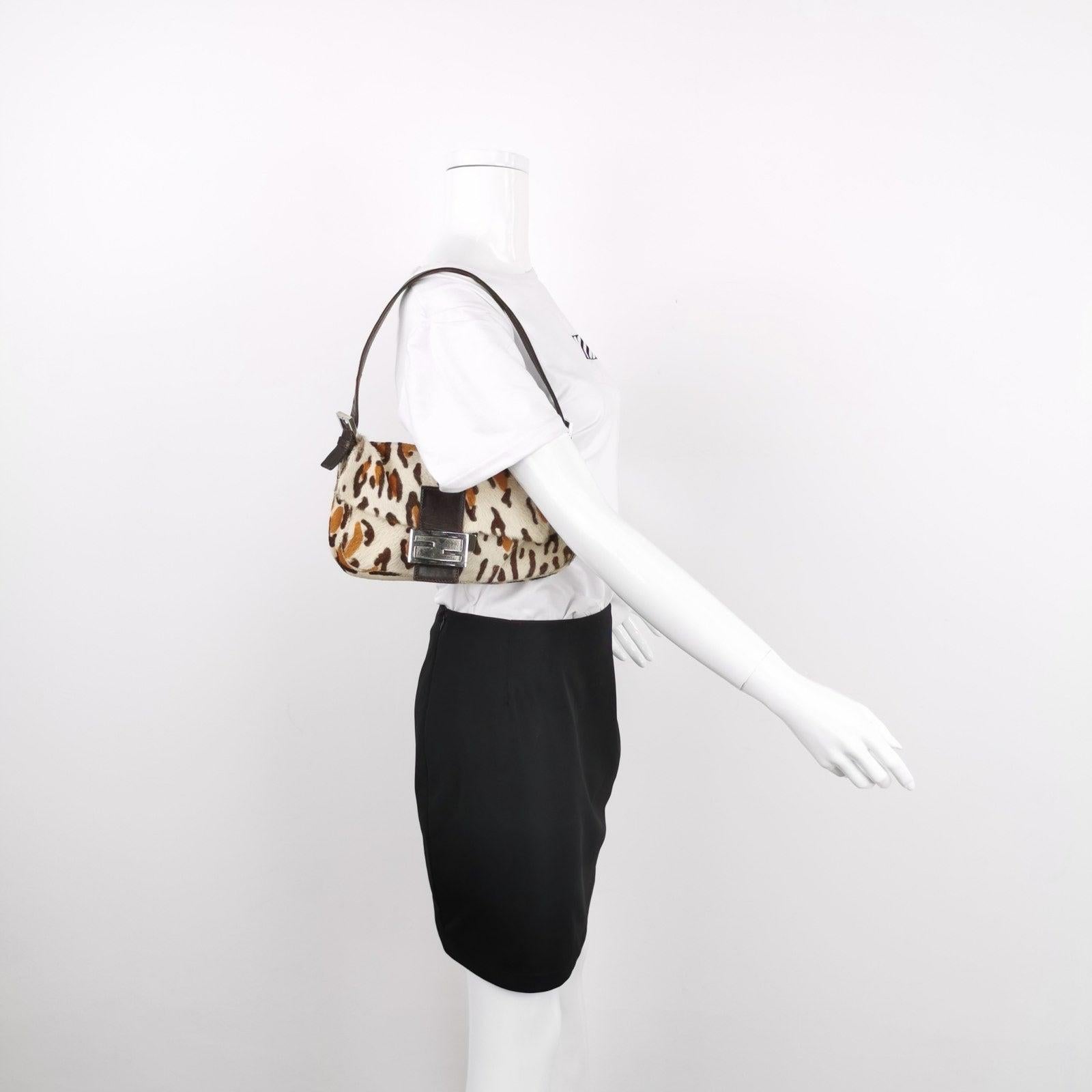 Fendi Baguette Pony hair in leopard print Brown
 These are professional photos of the actual bag.
 Get ahead of the fashion curve with the Fendi Baguette Pony hair shoulder bag in leopard print. Made with high-quality ponyhair and calfskin, this bag