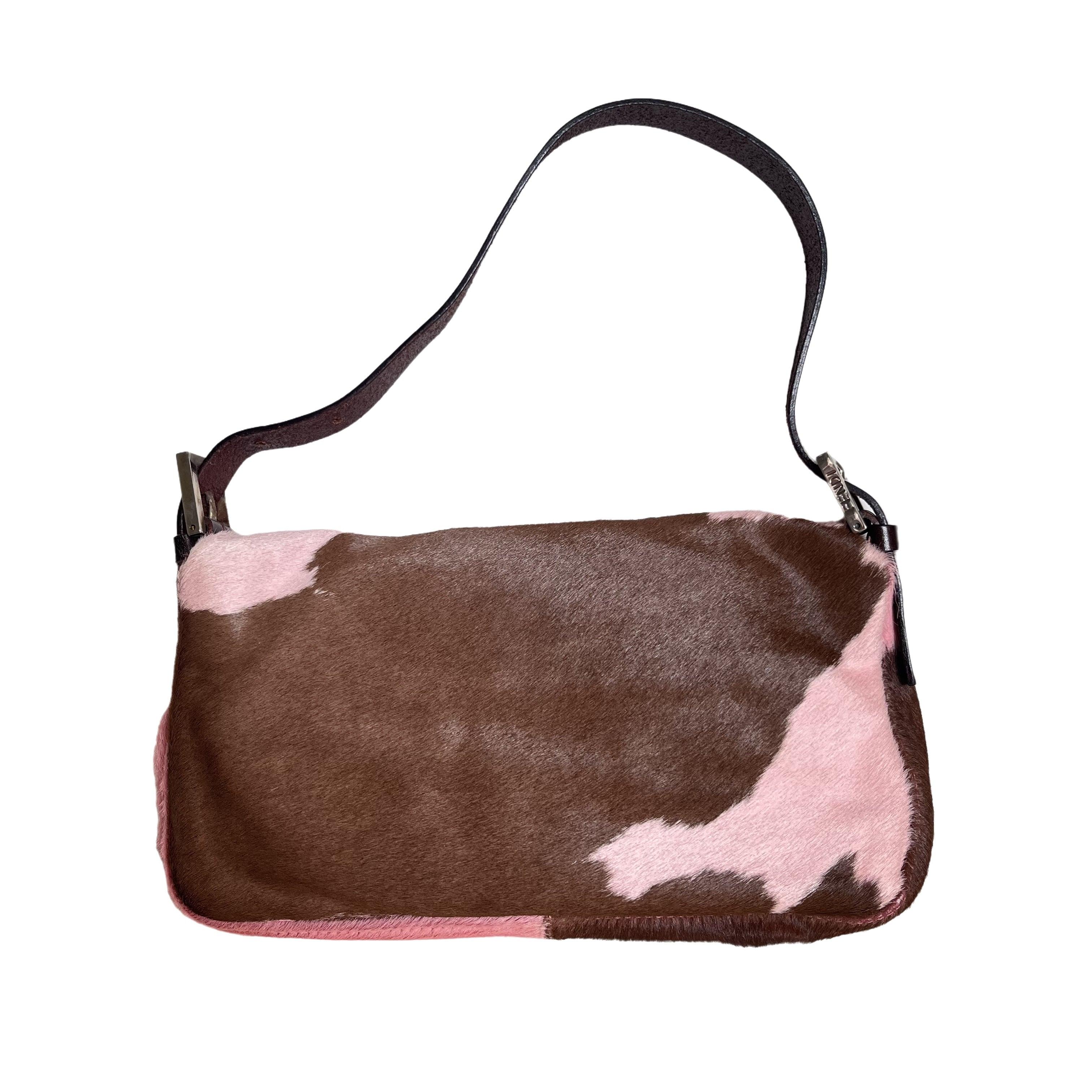 Fendi Baguette Pony-style Calfskin Leather Shoulder Bag in Pink Cow Print These are professional photos of the actual bag offered by Luxbags. Get ahead of the fashion curve with the Fendi Baguette Pony hair shoulder bag in cow print pink. Made with